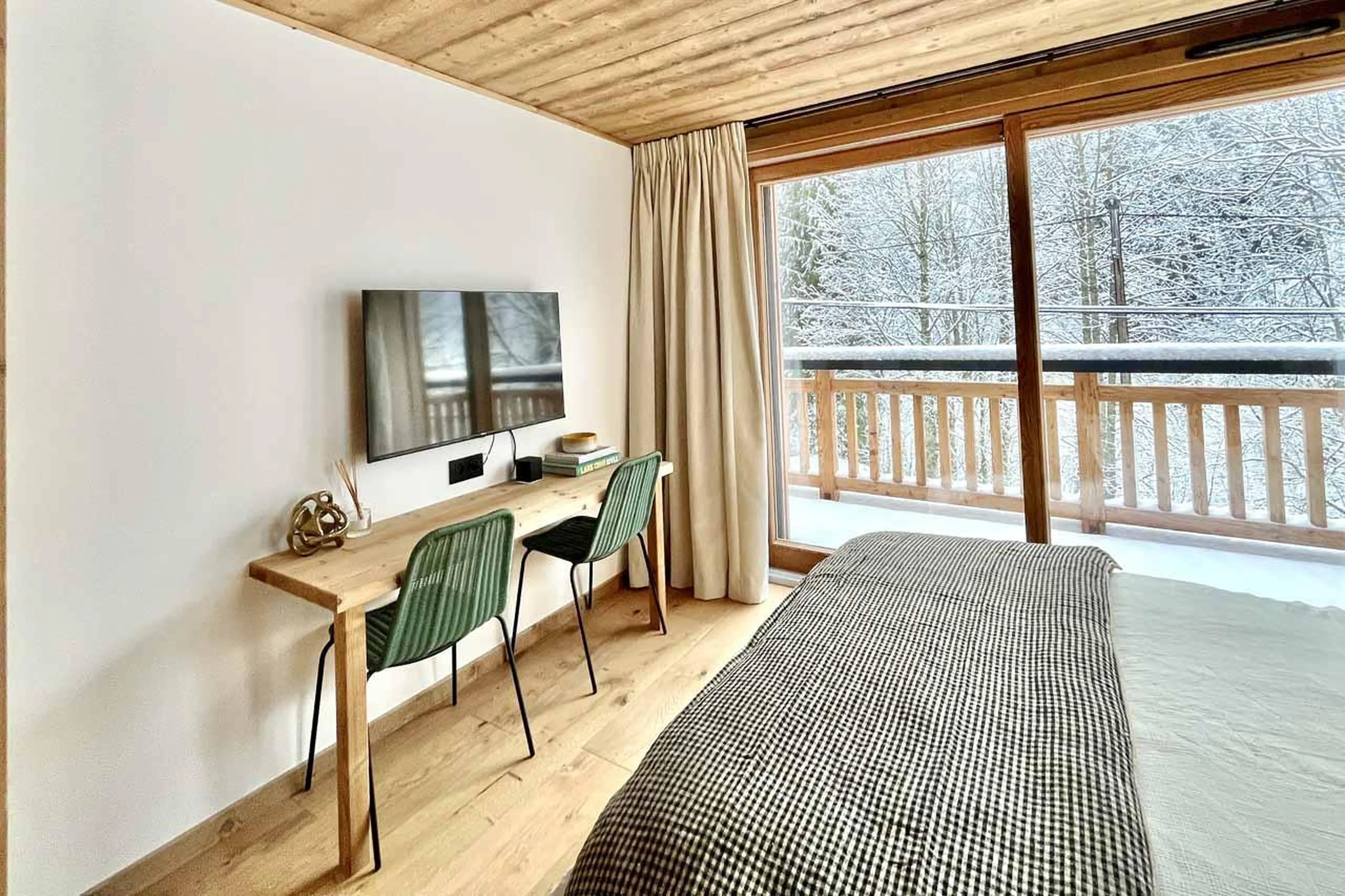 Double bedroom with TV, desk and sliding glass doors in Chalet Asgard, Morzine