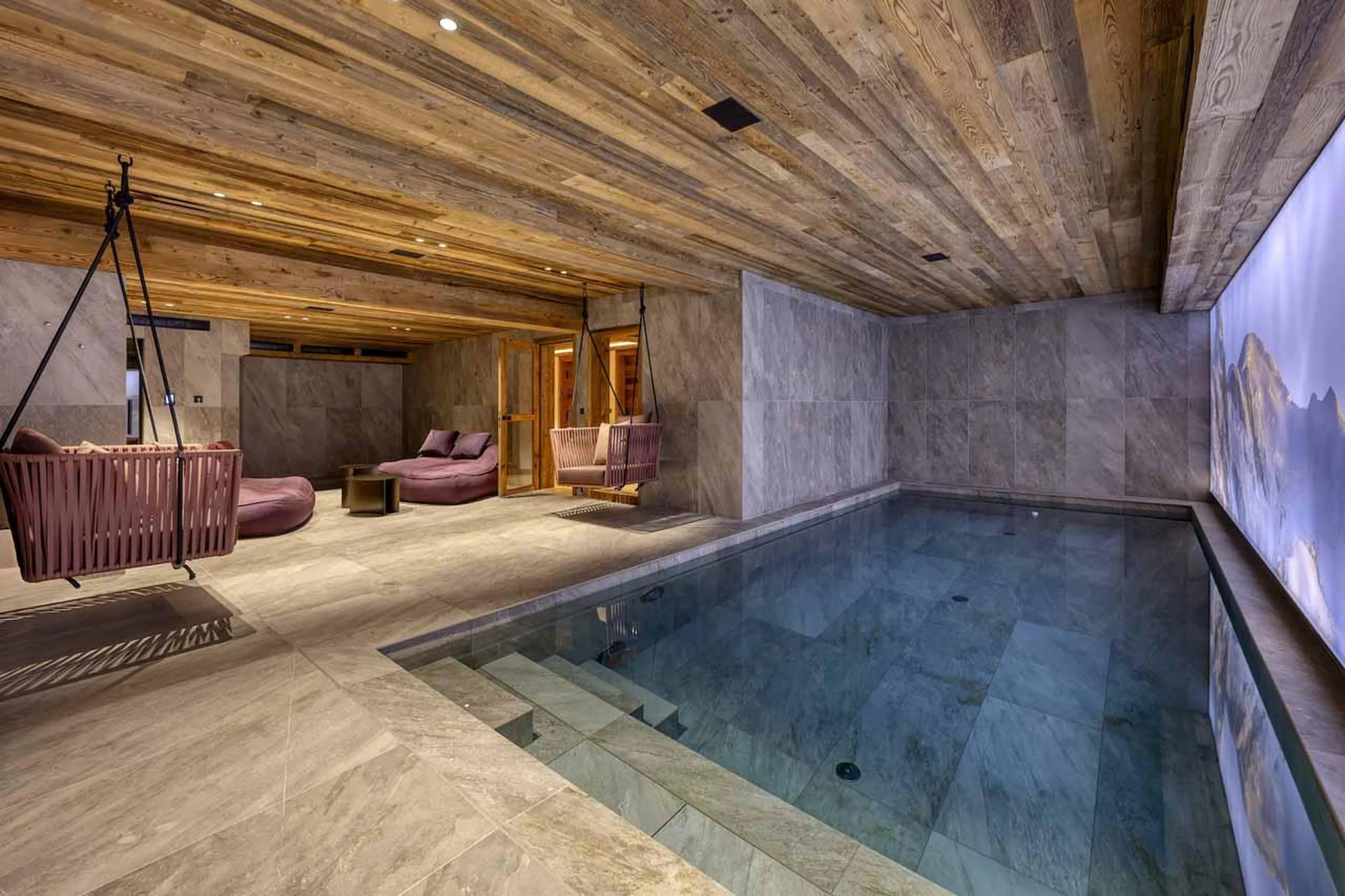 Indoor swimming pool and relaxation area with swings in Chalet Aspen, Megeve