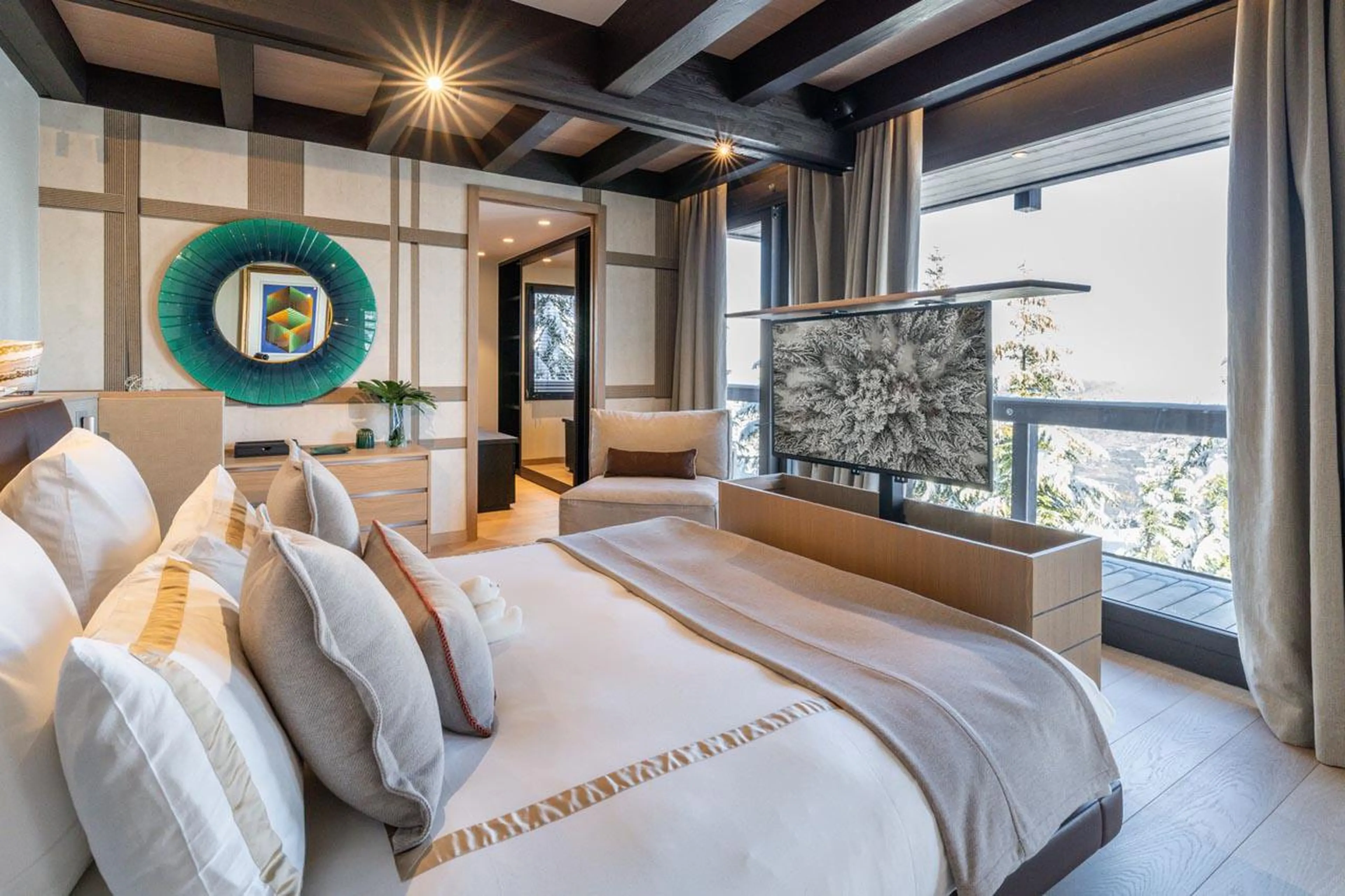 Double bedroom with balcony access at Chalet B in Courchevel 1850