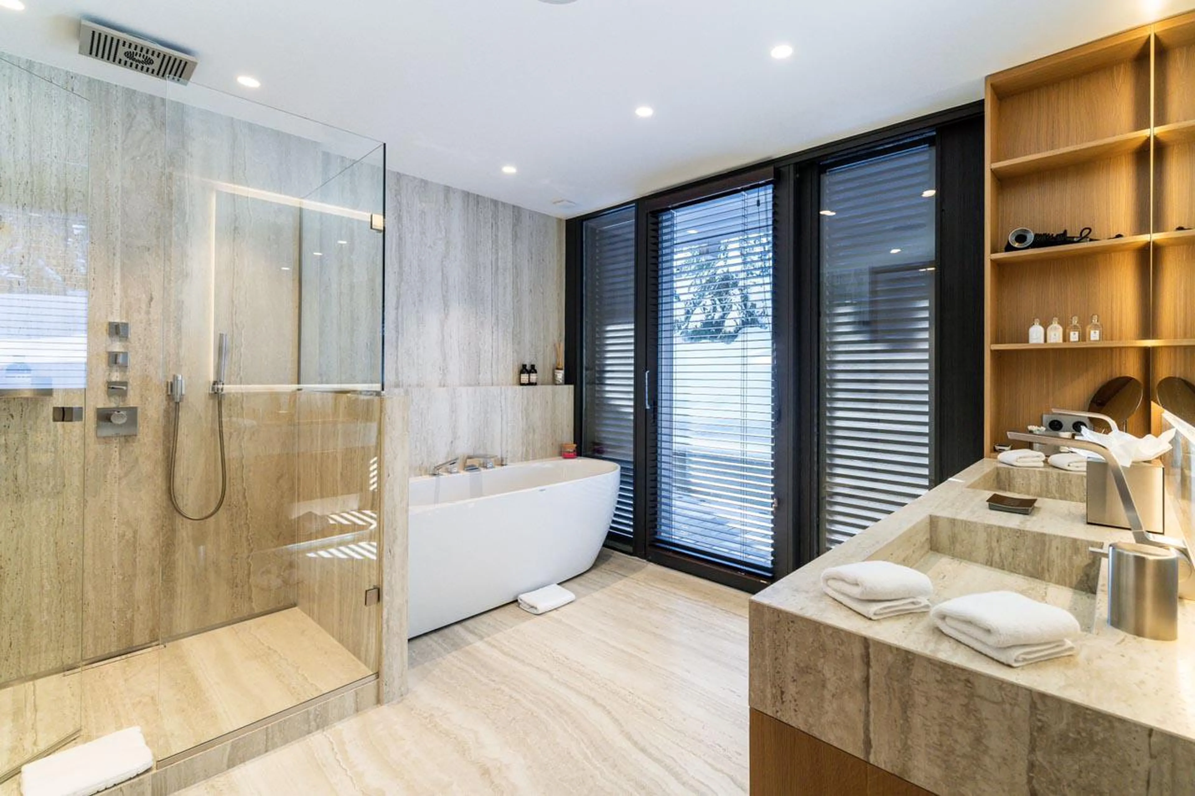 En-suite bathroom with bath and shower at Chalet B in Courchevel 1850