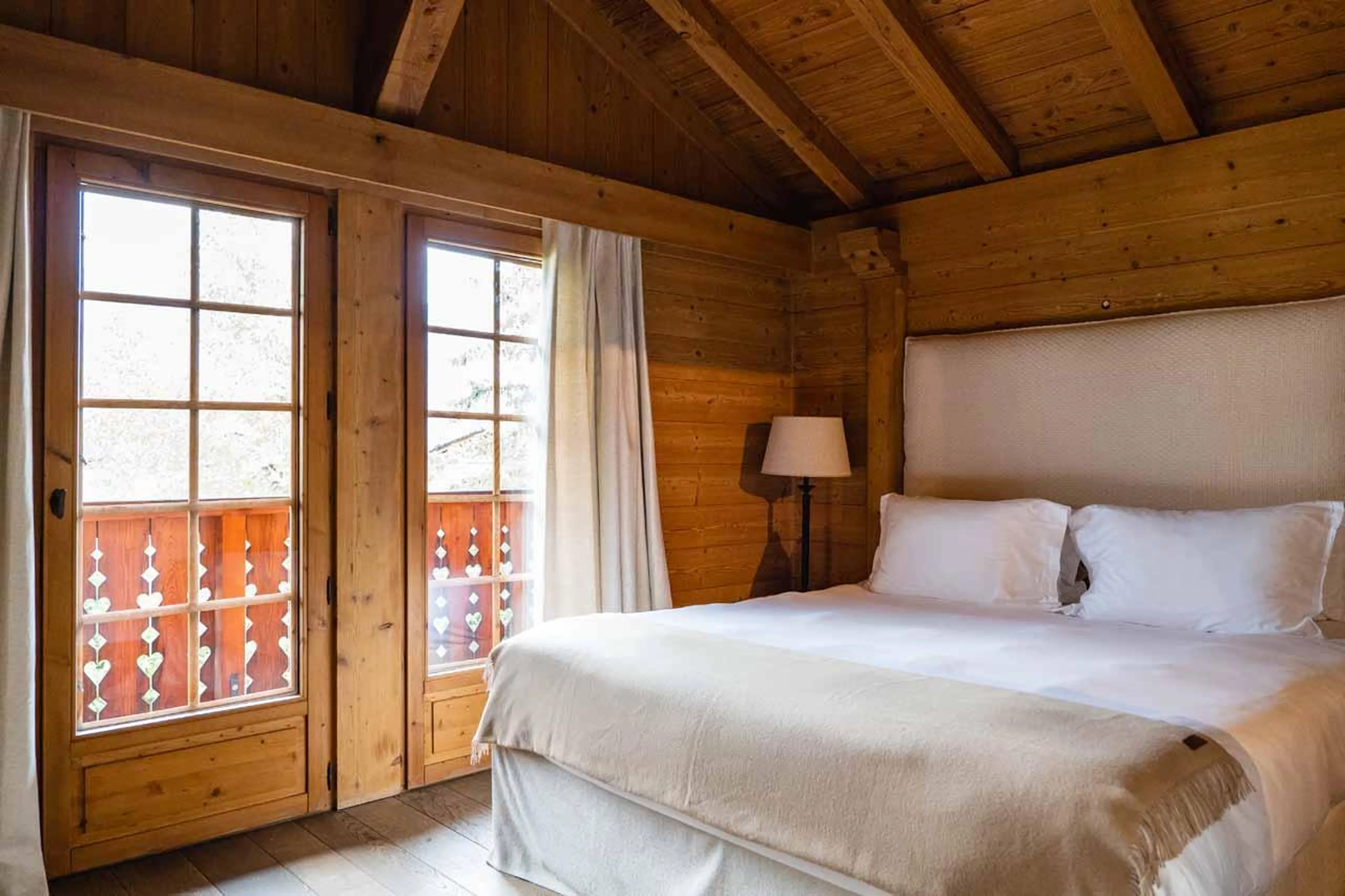 Double bedroom with French doors leading to balcony in Chalet Baltus, Megeve