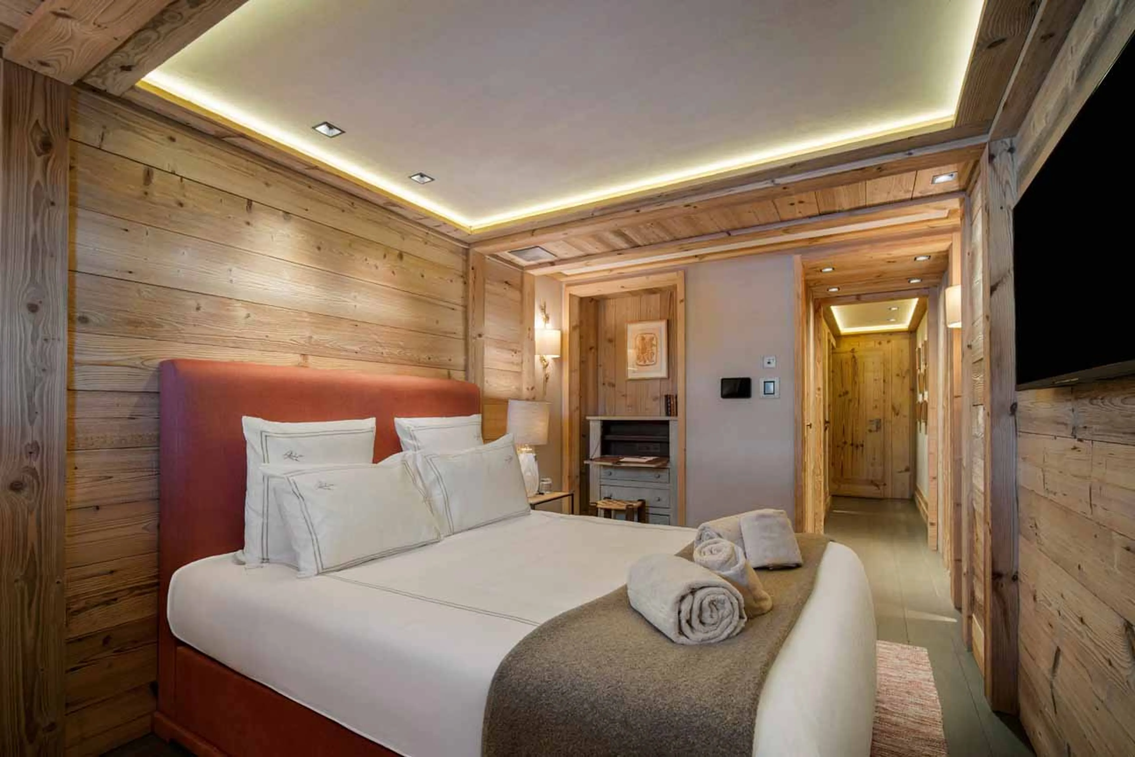 Bedroom with double bed, dressing area, en suite shower room in Chalet Les Bastidons  in Courchevel