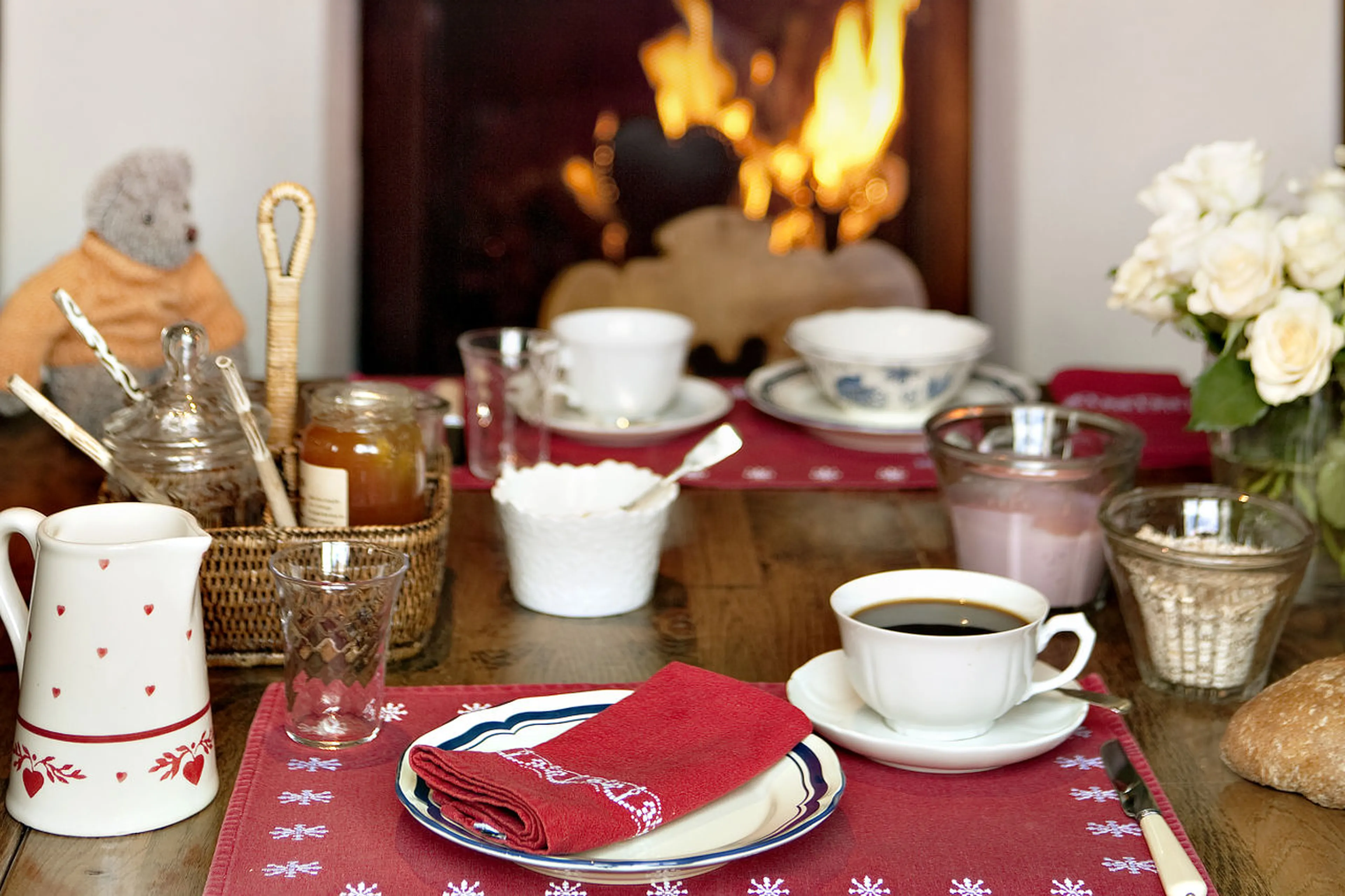 Dining area with a glowing fireplace in Chalet Bear in Klosters