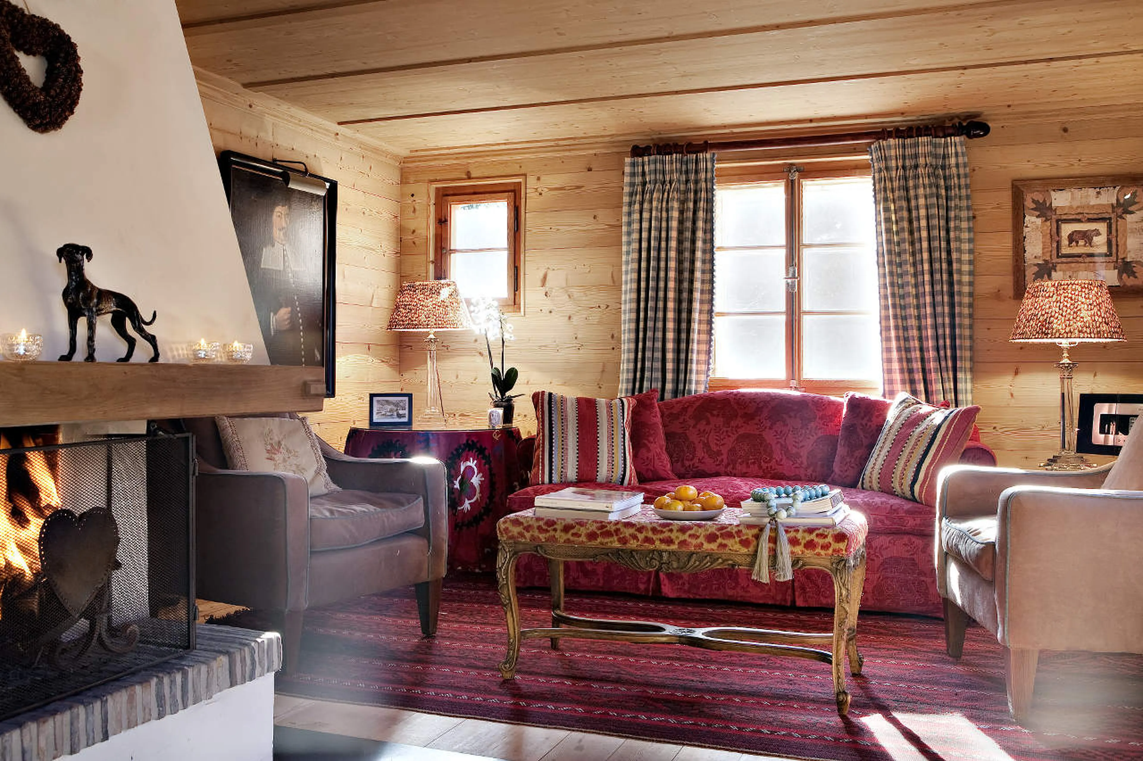 Living area with a fireplace in Chalet Bear in Klosters