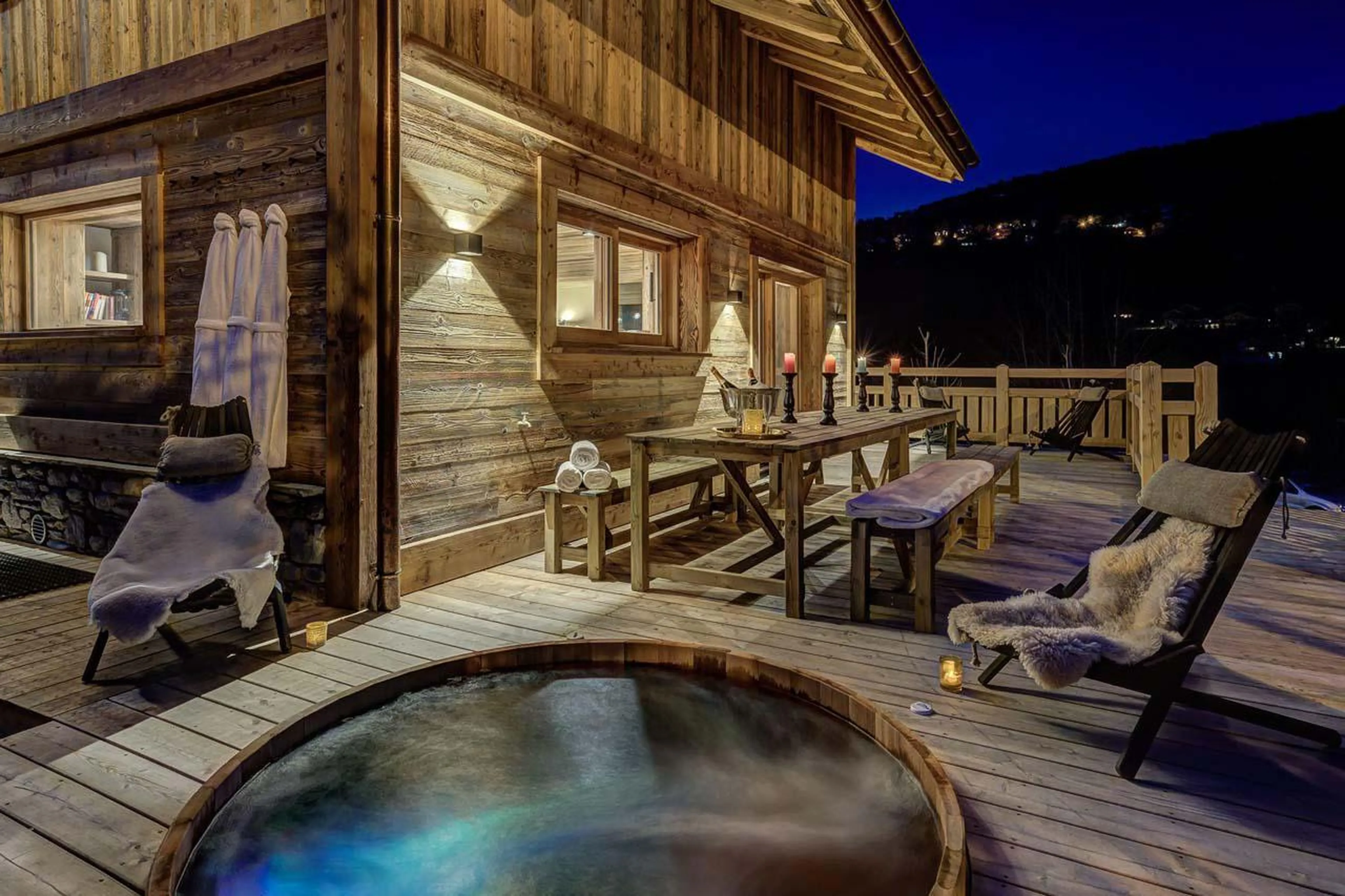 Outdoor hot tub and space for alfresco dining at Chalet Bergeronnette in Meribel