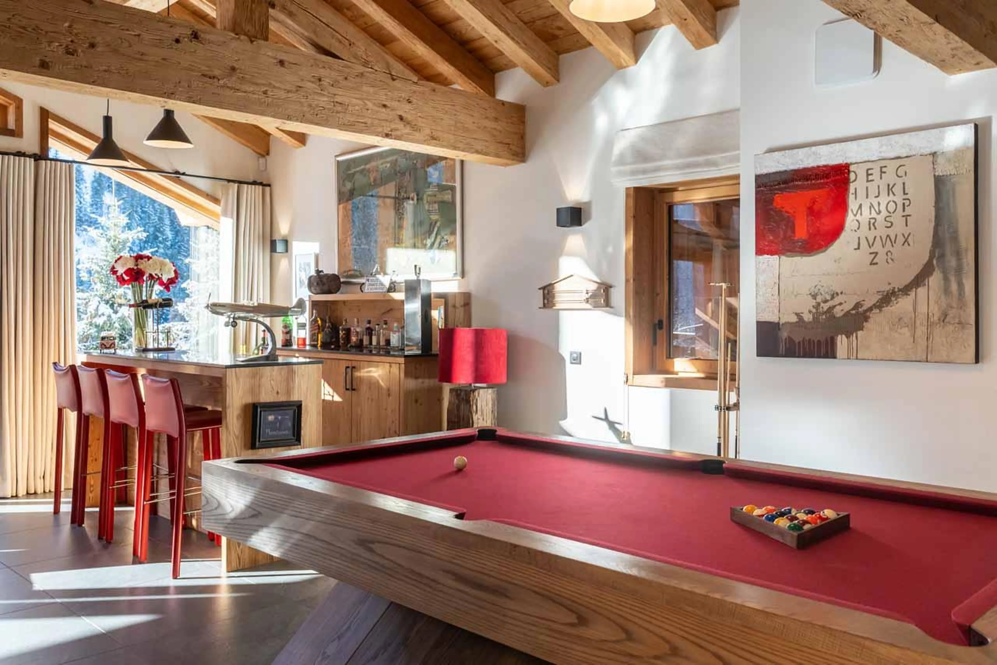 Living area with bar and pool table at Chalet Berlioz in Meribel