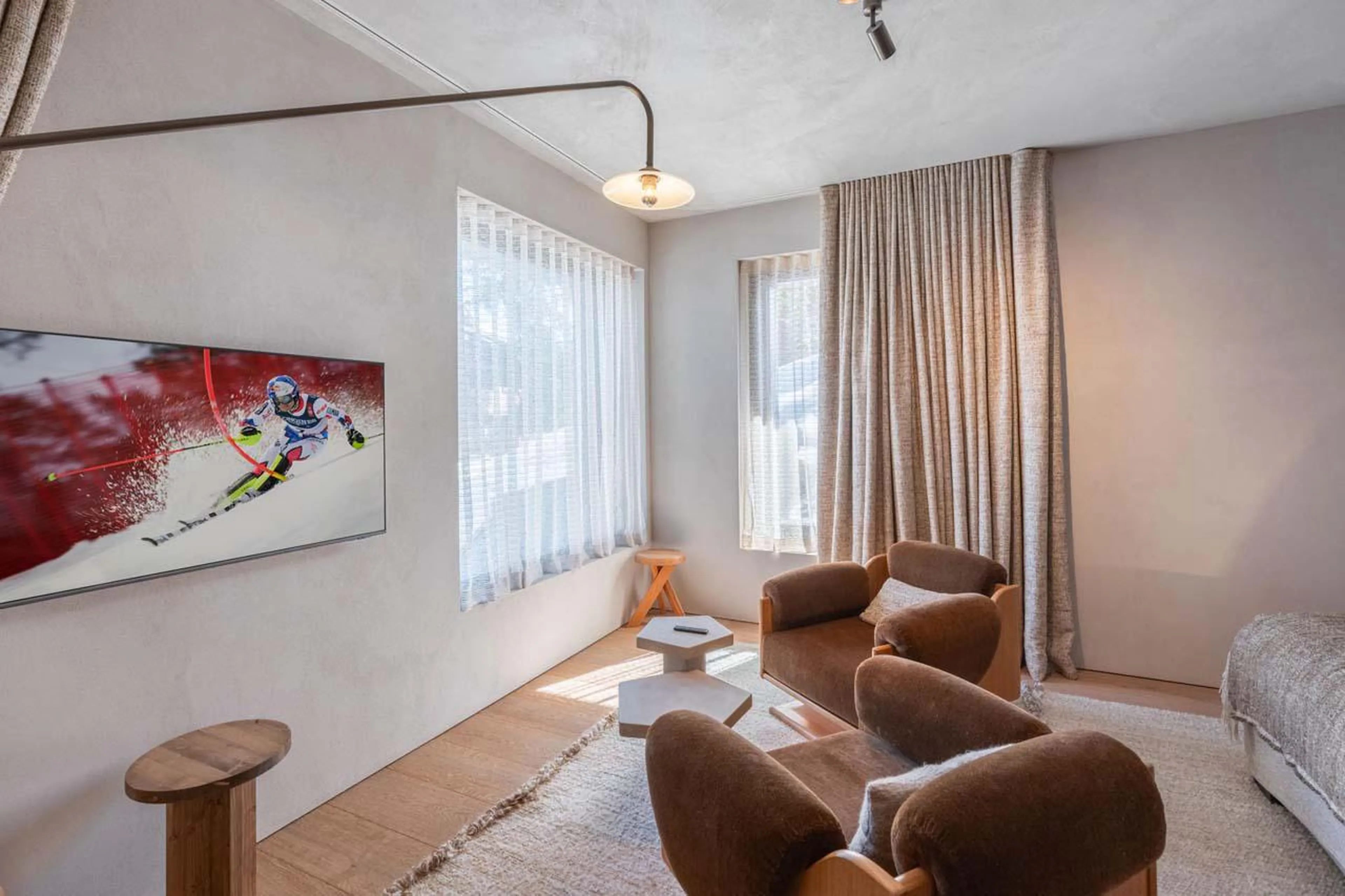 Modern bedroom with TV and comfortable seating at Chalet Black Lodge in Courchevel 1850