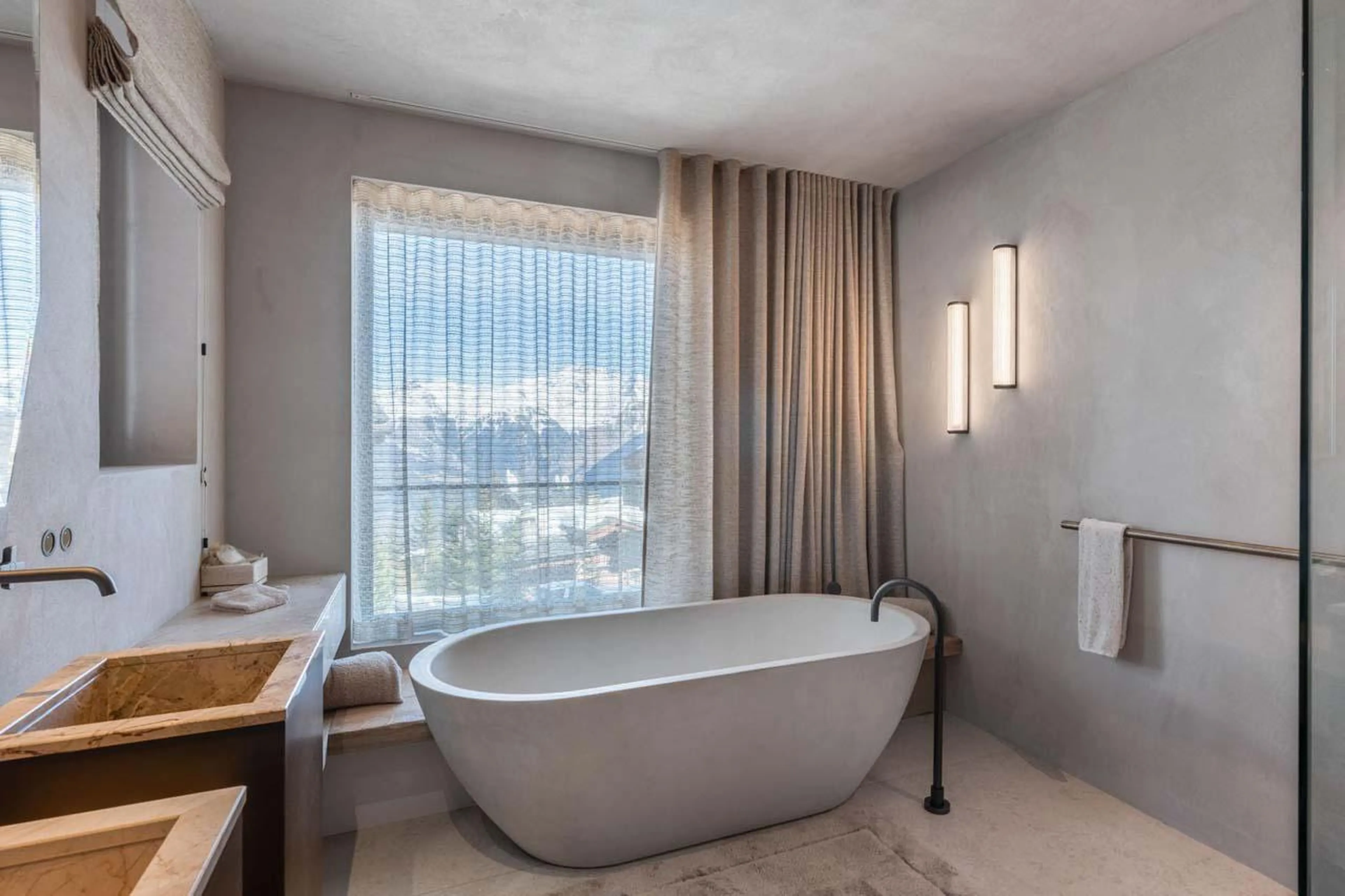 En-suite bathroom with bath and shower at Chalet Black Lodge in Courchevel 1850
