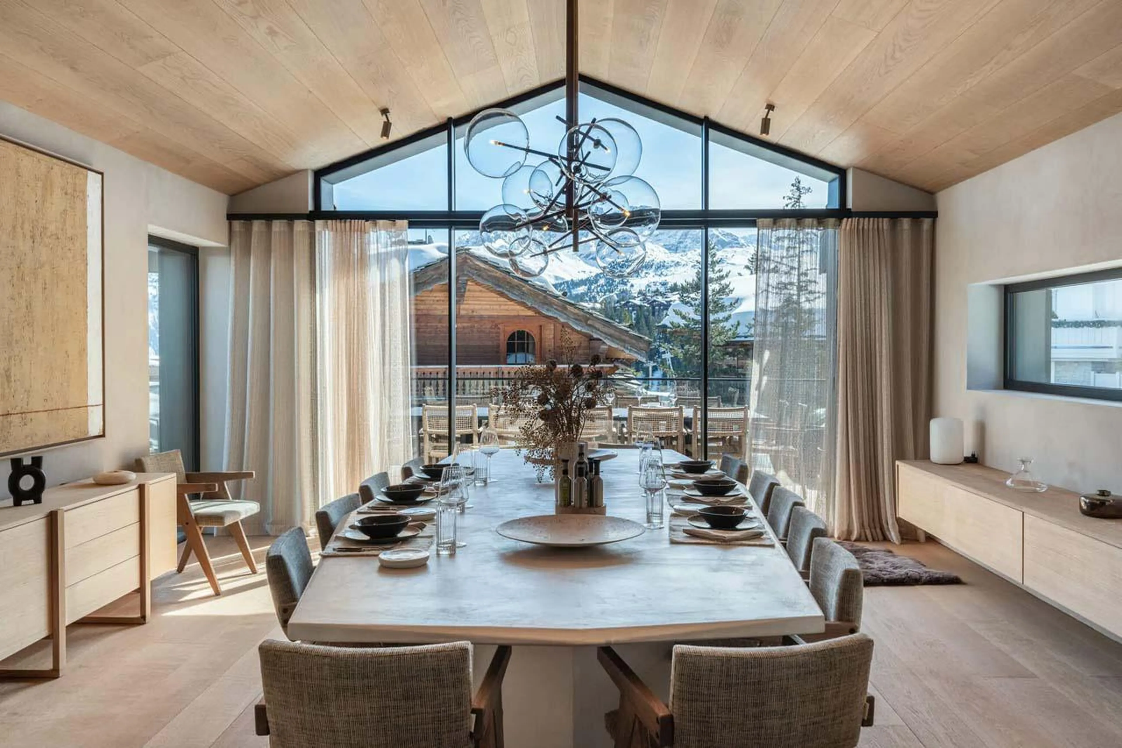 Dining table with panoramic mountain views at Chalet Black Lodge in Courchevel 1850