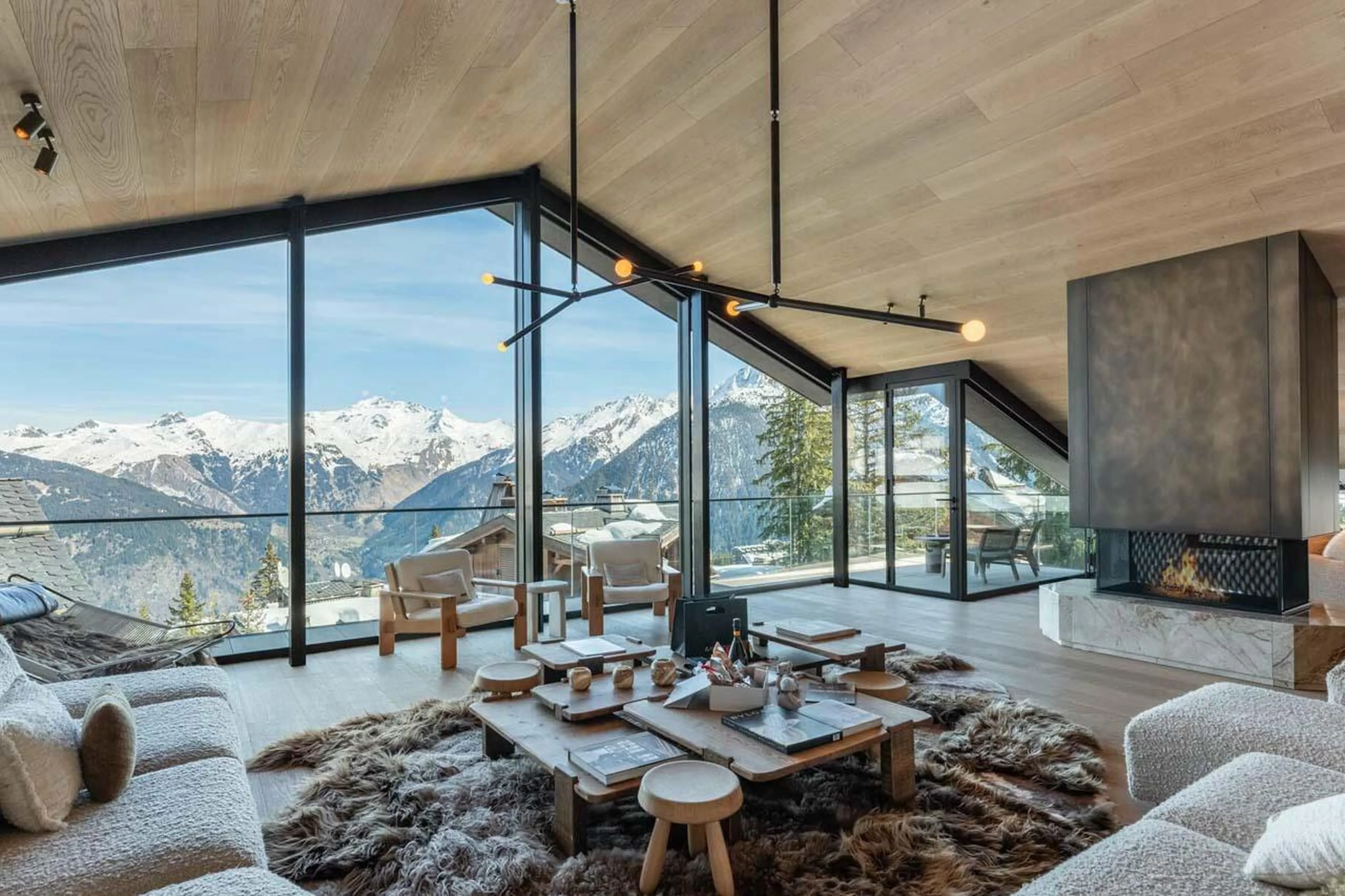 Living space overlooking sweeping mountain views at Chalet Black Lodge in Courchevel 1850