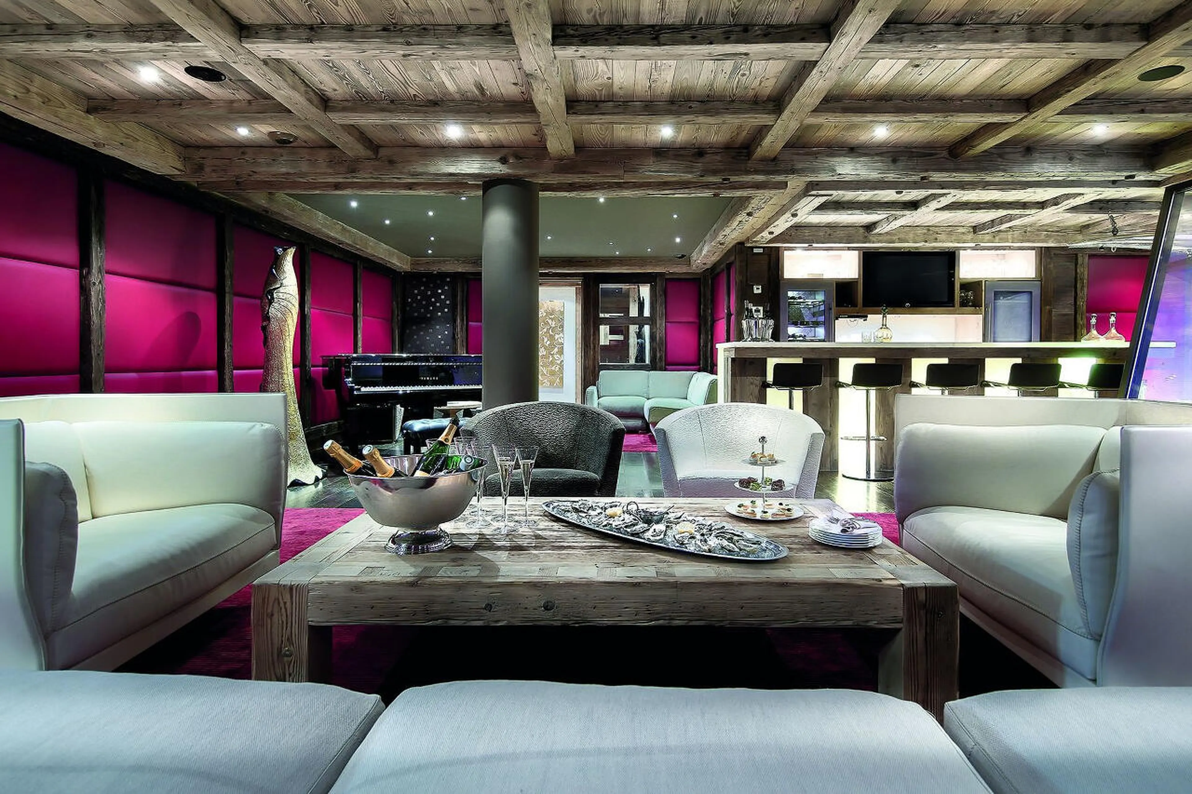 Club lounge featuring a piano, bar and fireplace in Chalet Black Pearl in Courchevel 1850