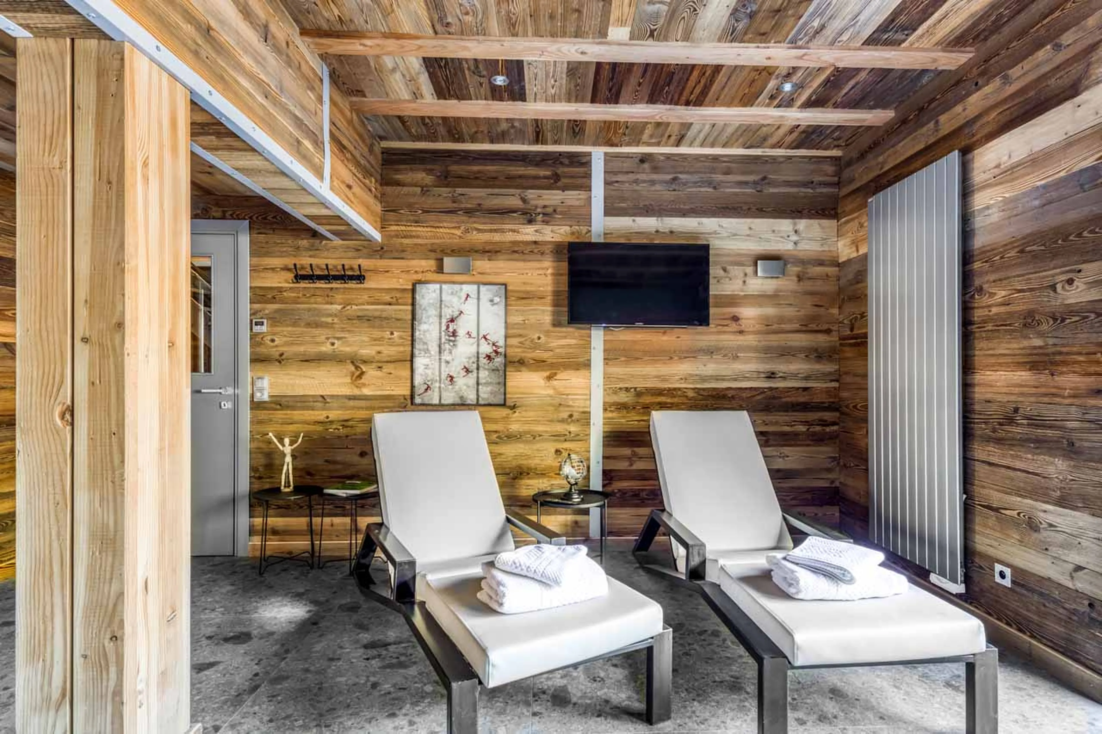 Sun loungers in private spa area at Chalet Charlie in Tignes