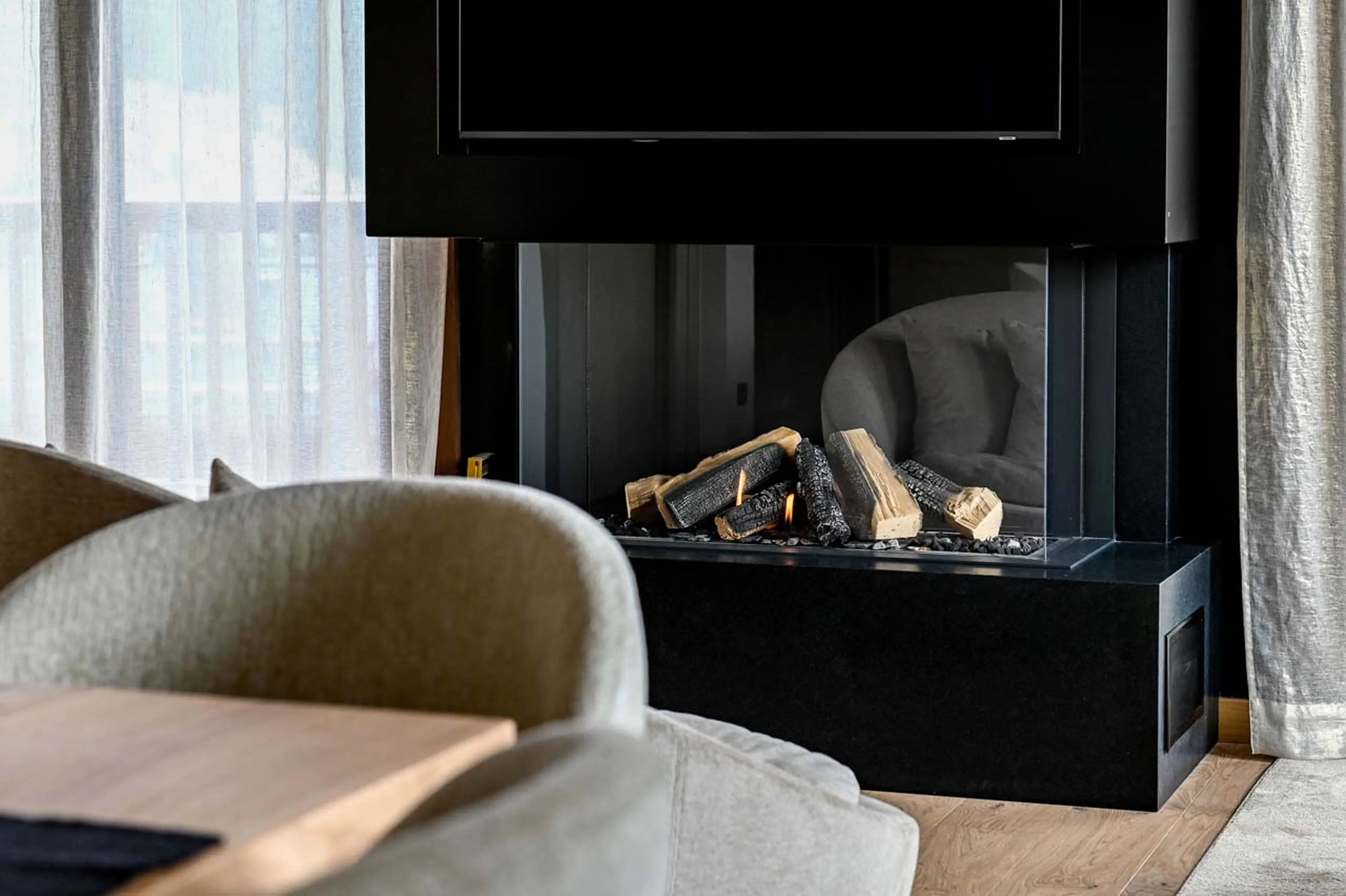 Gas fireplace in living area of Chalet Chasse Forêt in Courchevel 1650