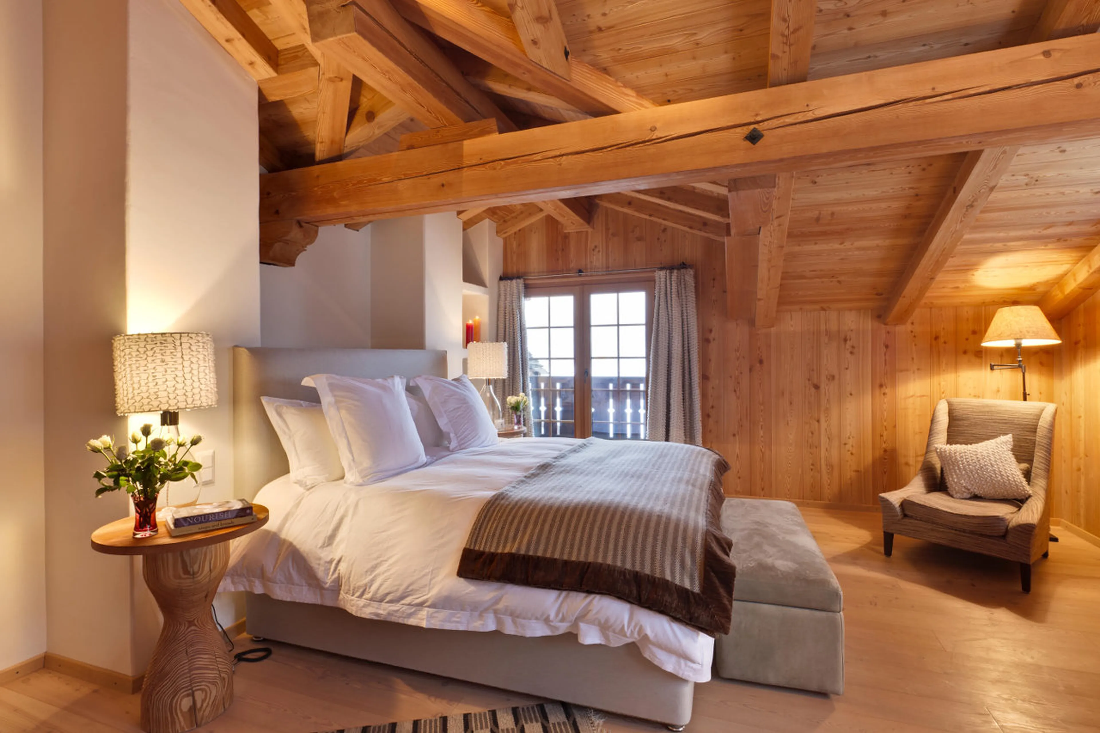 Master en-suite double bedroom with balcony access in Chalet Chimera in Klosters
