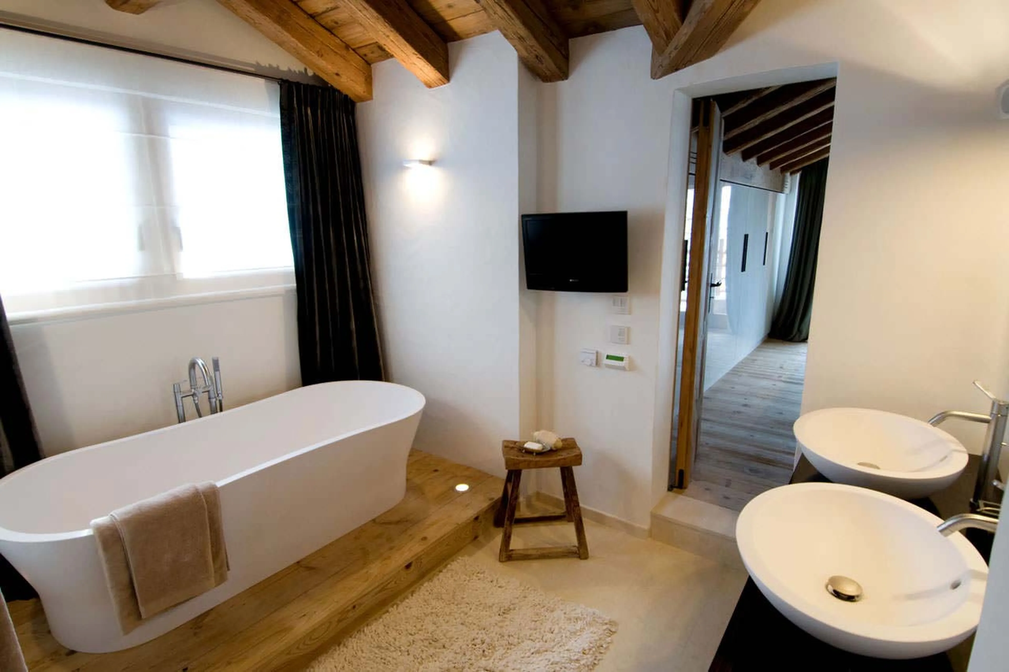 TV in master bathroom at Chalet Dent Blanche in Verbier