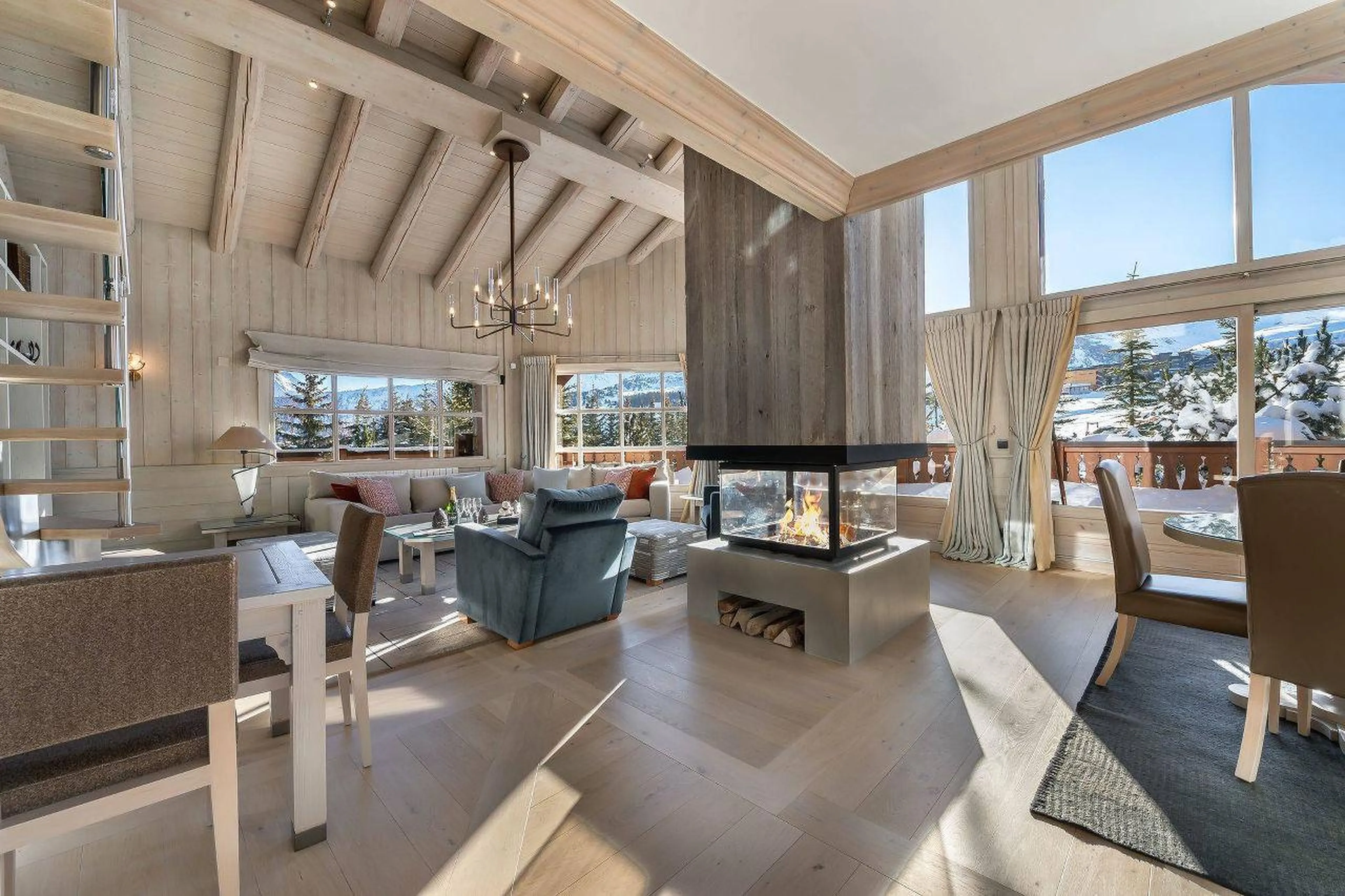 Living area with central fireplace in Chalet Edelstone, Courchevel 1850