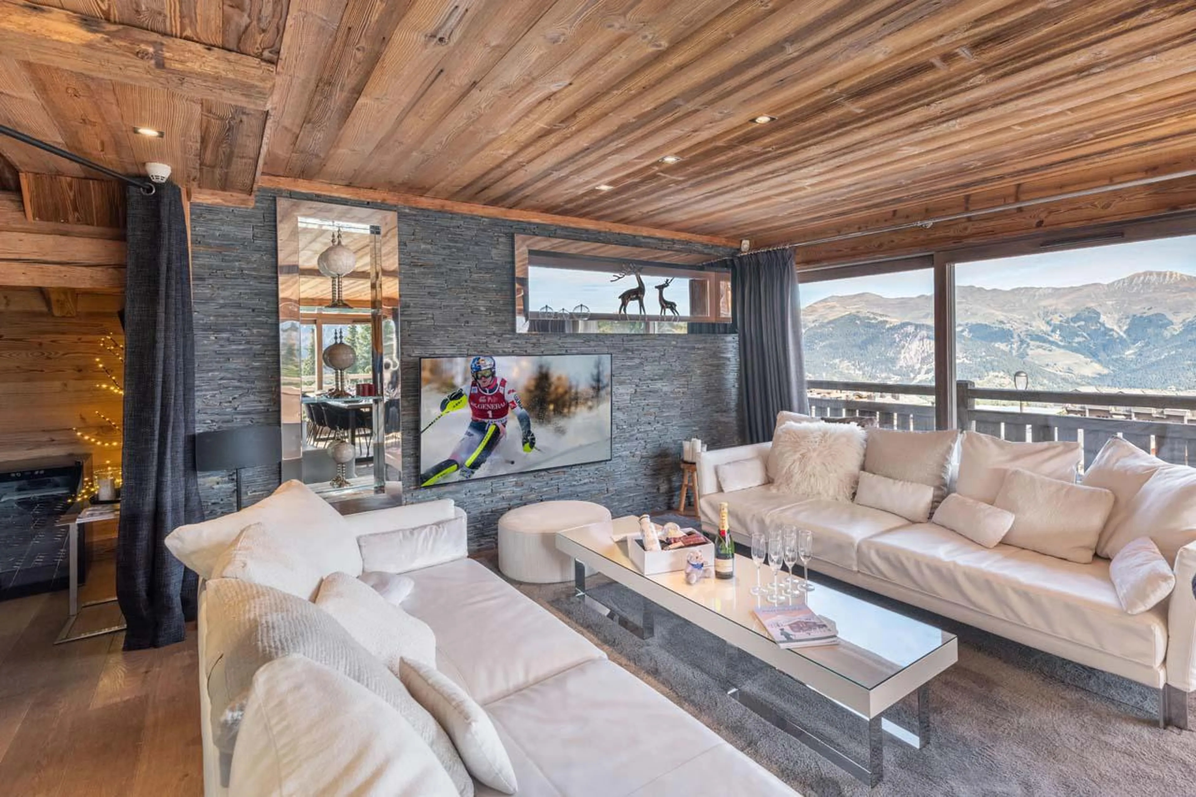 Lounge with balcony access and ethanol fireplace in Chalet Eden in Courchevel 1850