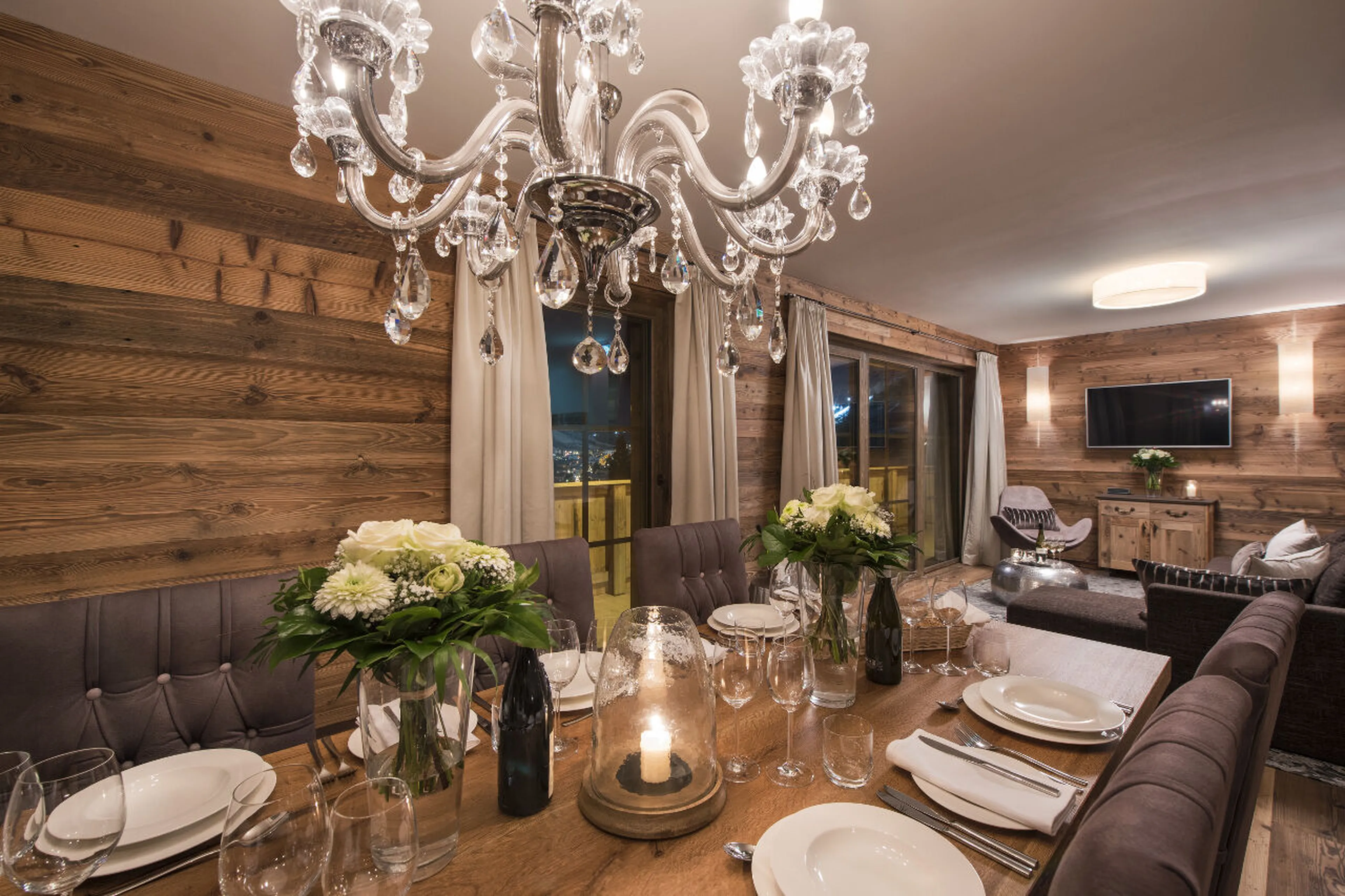 Living and dining area at night in Apartment Zari in St Anton