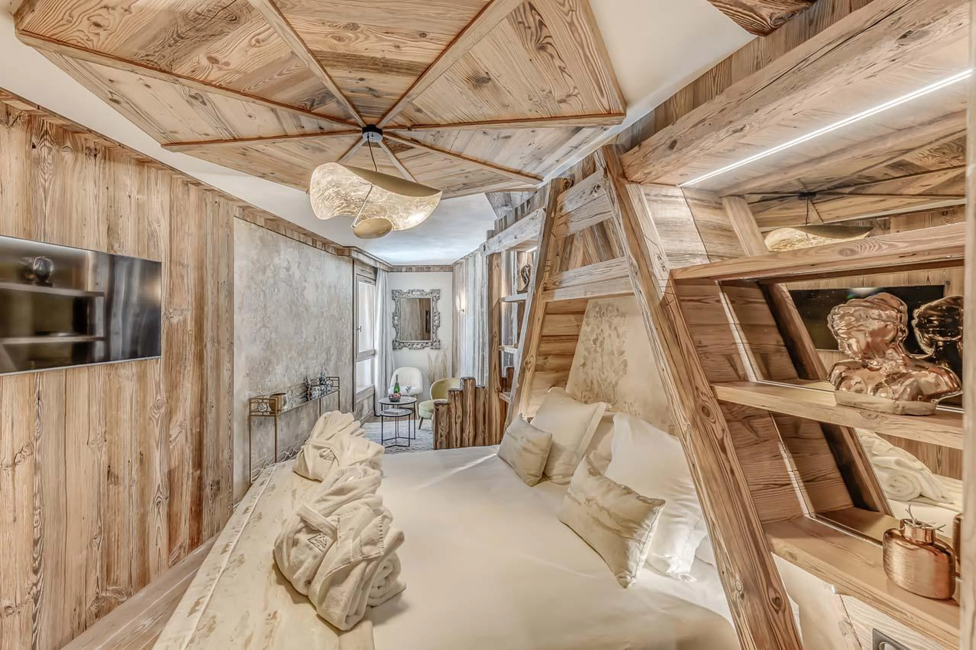 Wooden furnishings and TV at Chalet Ganga in Tignes