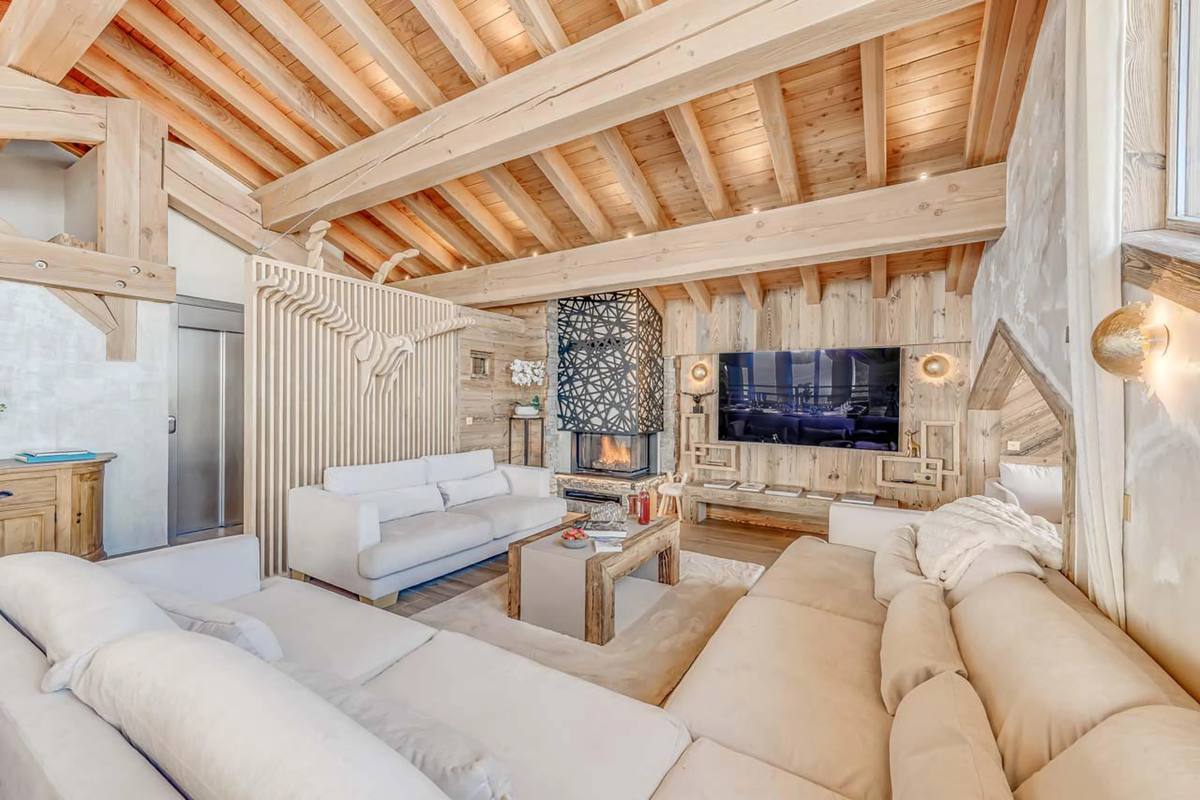 Homely sofa area with TV and sound system at Chalet Ganga in Tignes