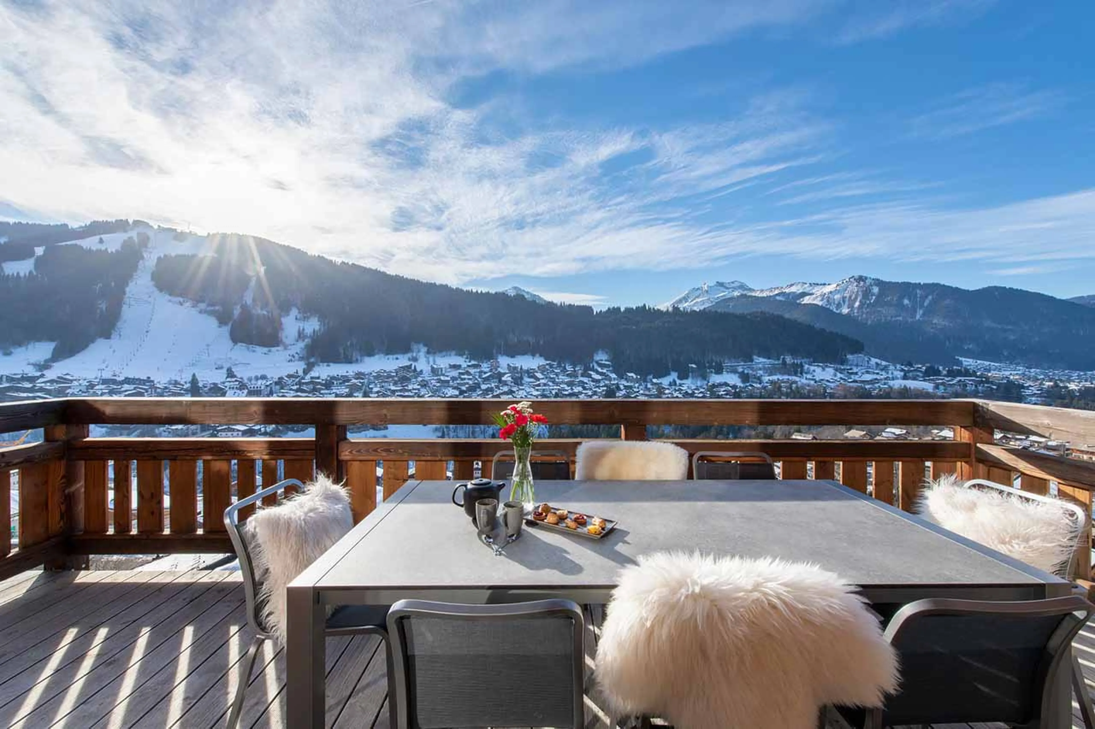 Wrap-around balcony with dining table at Chalet Goldilocks & Three Bears in Morzine