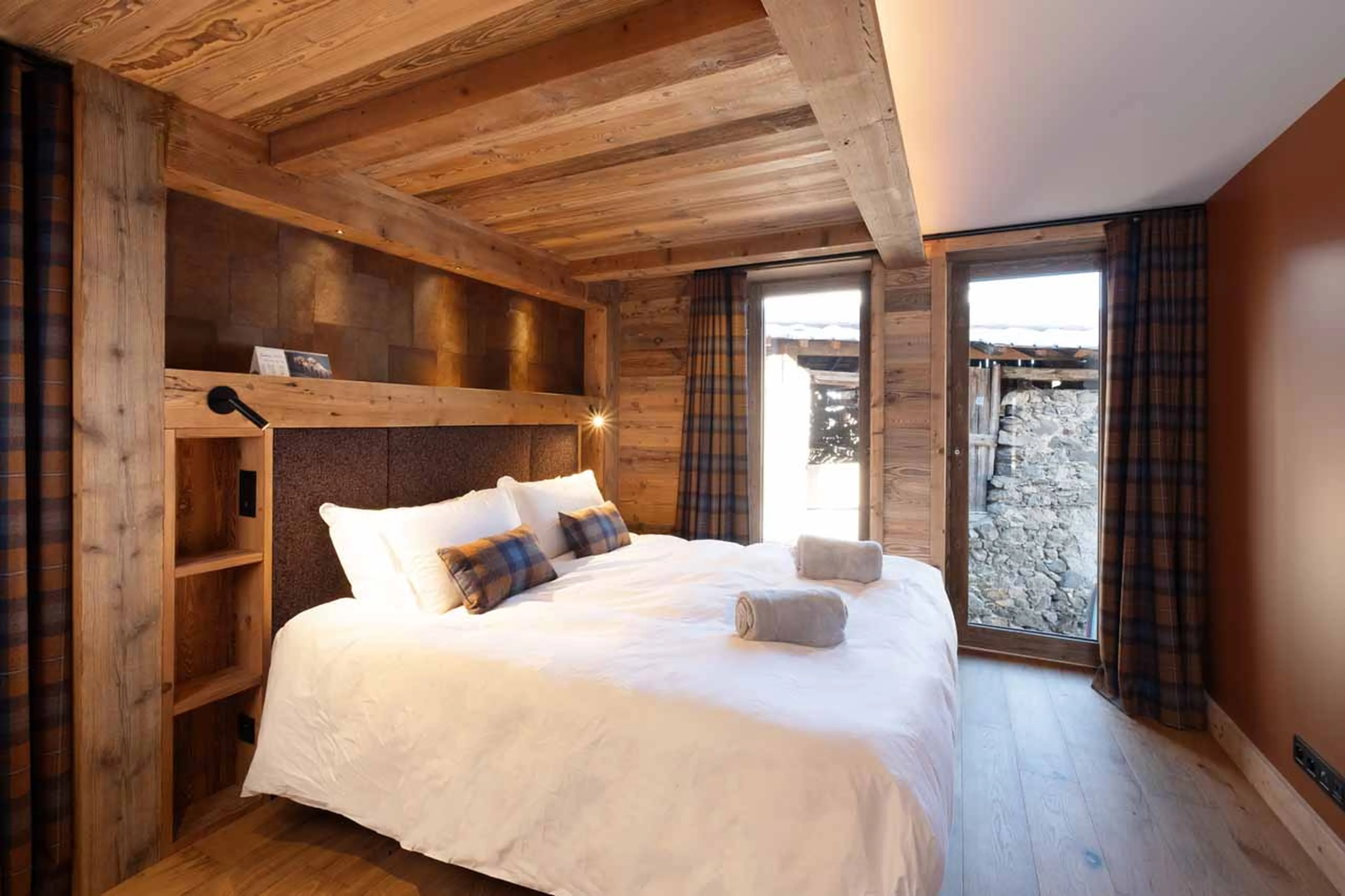 Double bedroom with floor-to-ceiling windows in Chalet Grande Kalinka, Meribel