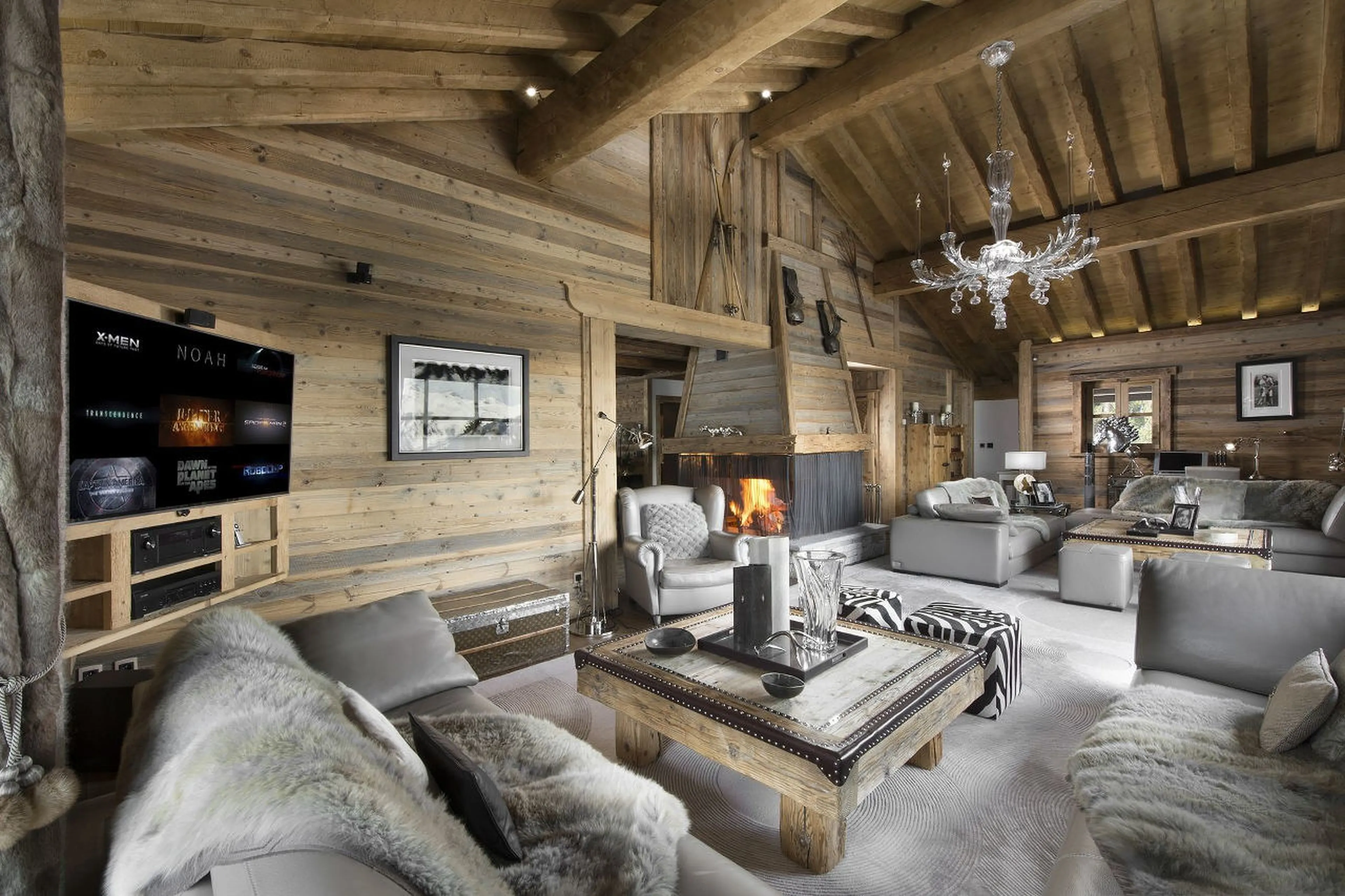 Stylish living area with central fireplace in Chalet La Grande Roche in Courchevel 1850