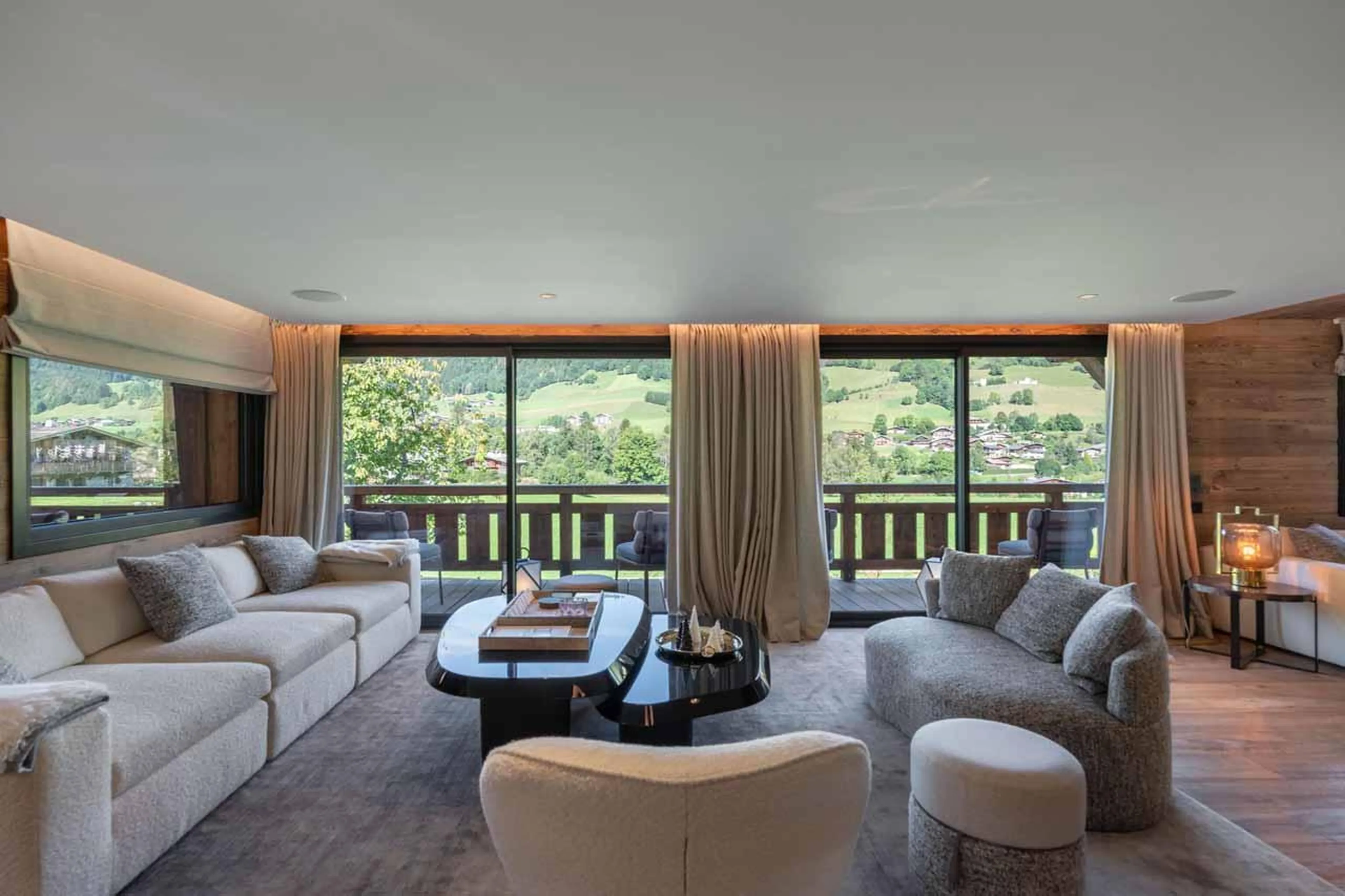 Sofas, armchairs and sliding glass doors in Chalet Grizzly, Megeve