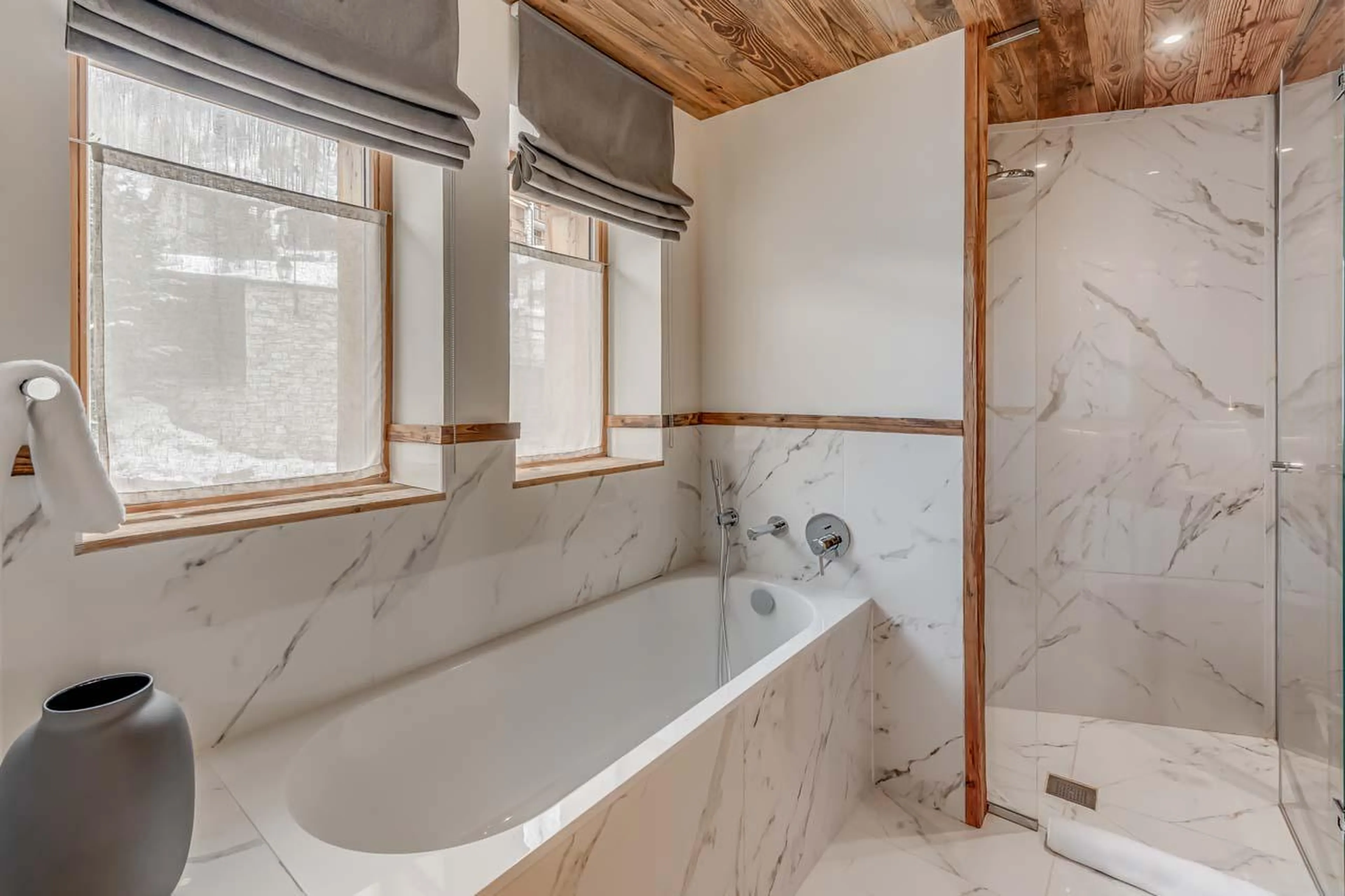 En-suite bathroom with bath and shower at Chalet Juno in Val d'Isere