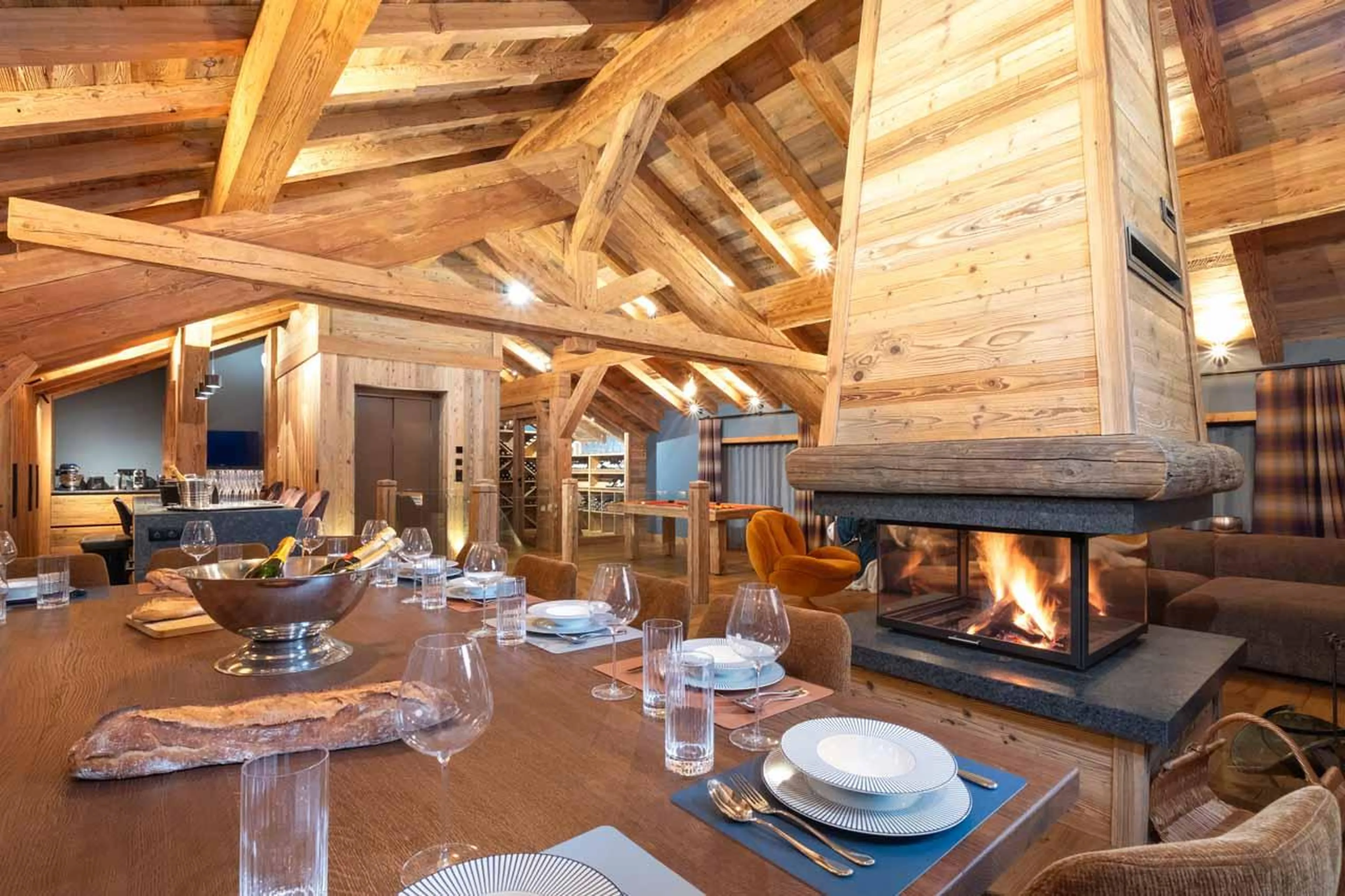Dining table and fireplace in Chalet Kalinka, Meribel