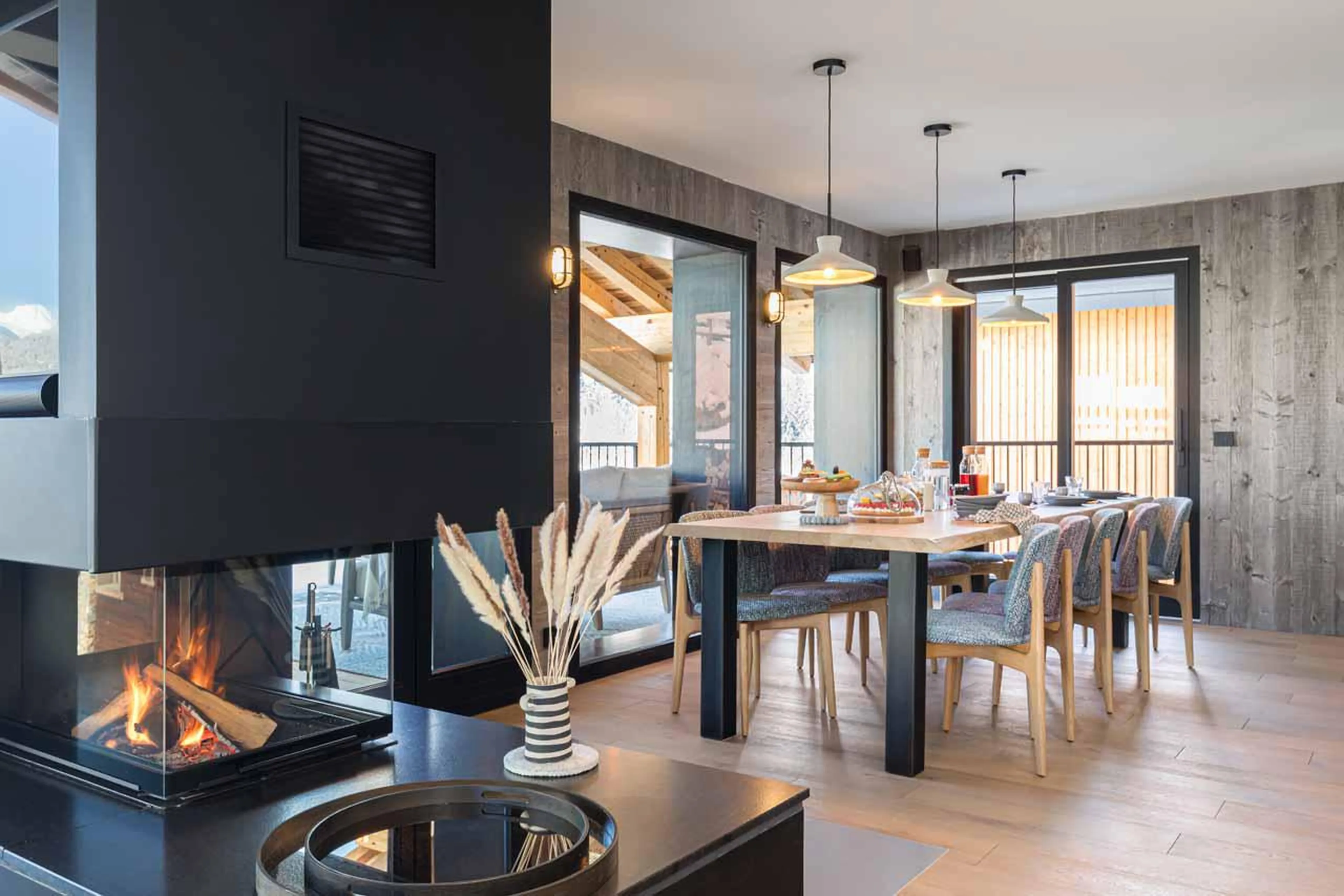 Fireplace positioned central within the open-plan living room at Chalet Kandahar in Courchevel 1550