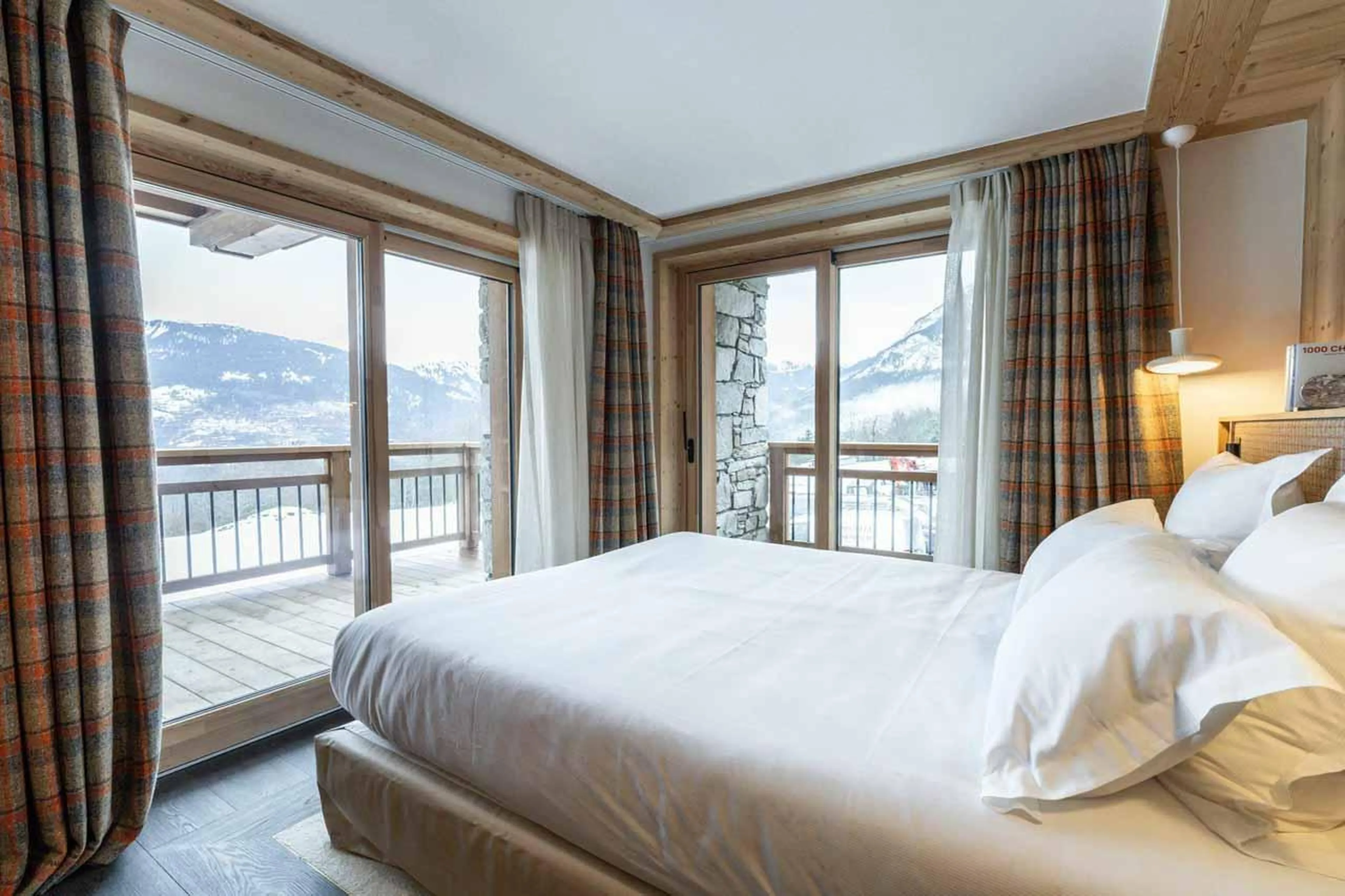 Double bedroom with sliding glass doors leading to balcony in Chalet Khoton, Courchevel Le Praz