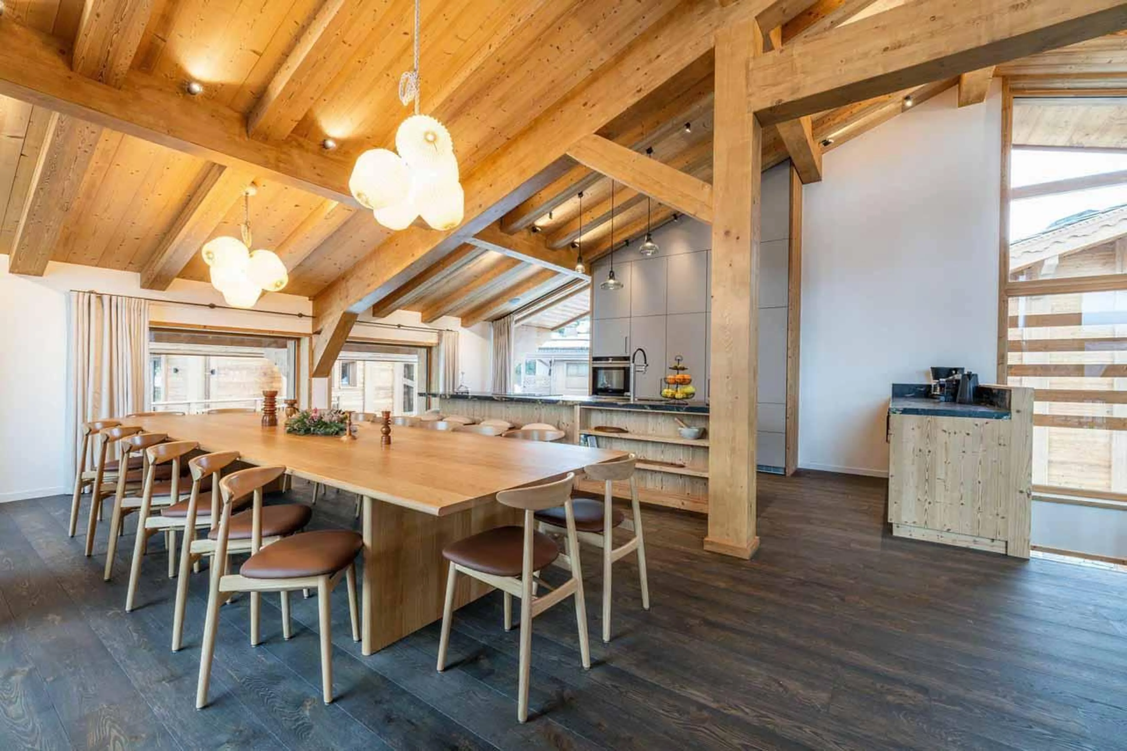 Dining table in front of kitchen in Chalet Khoton, Courchevel Le Praz