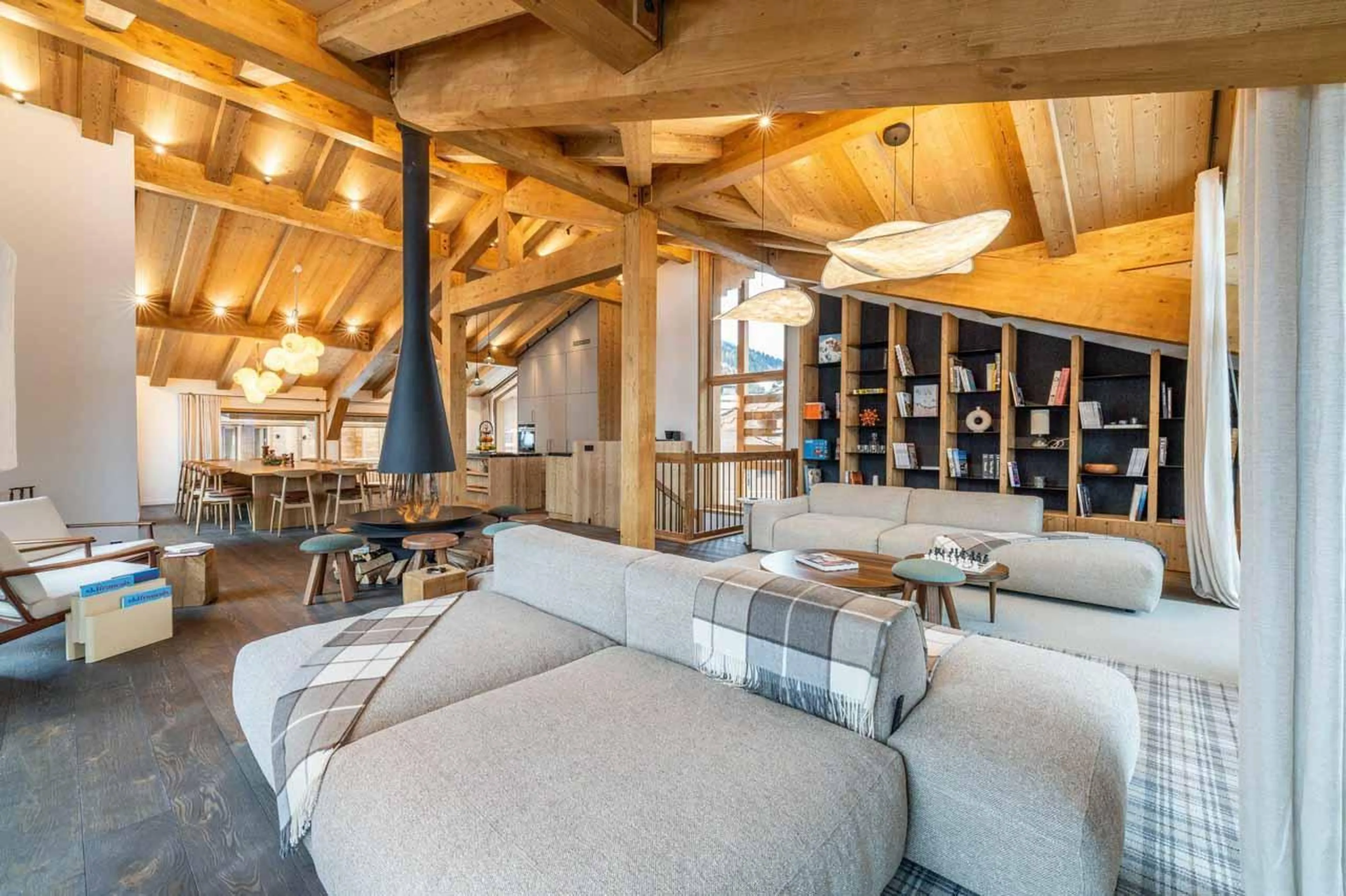Sofas, fireplace and dining table in Chalet Khoton, Courchevel Le Praz