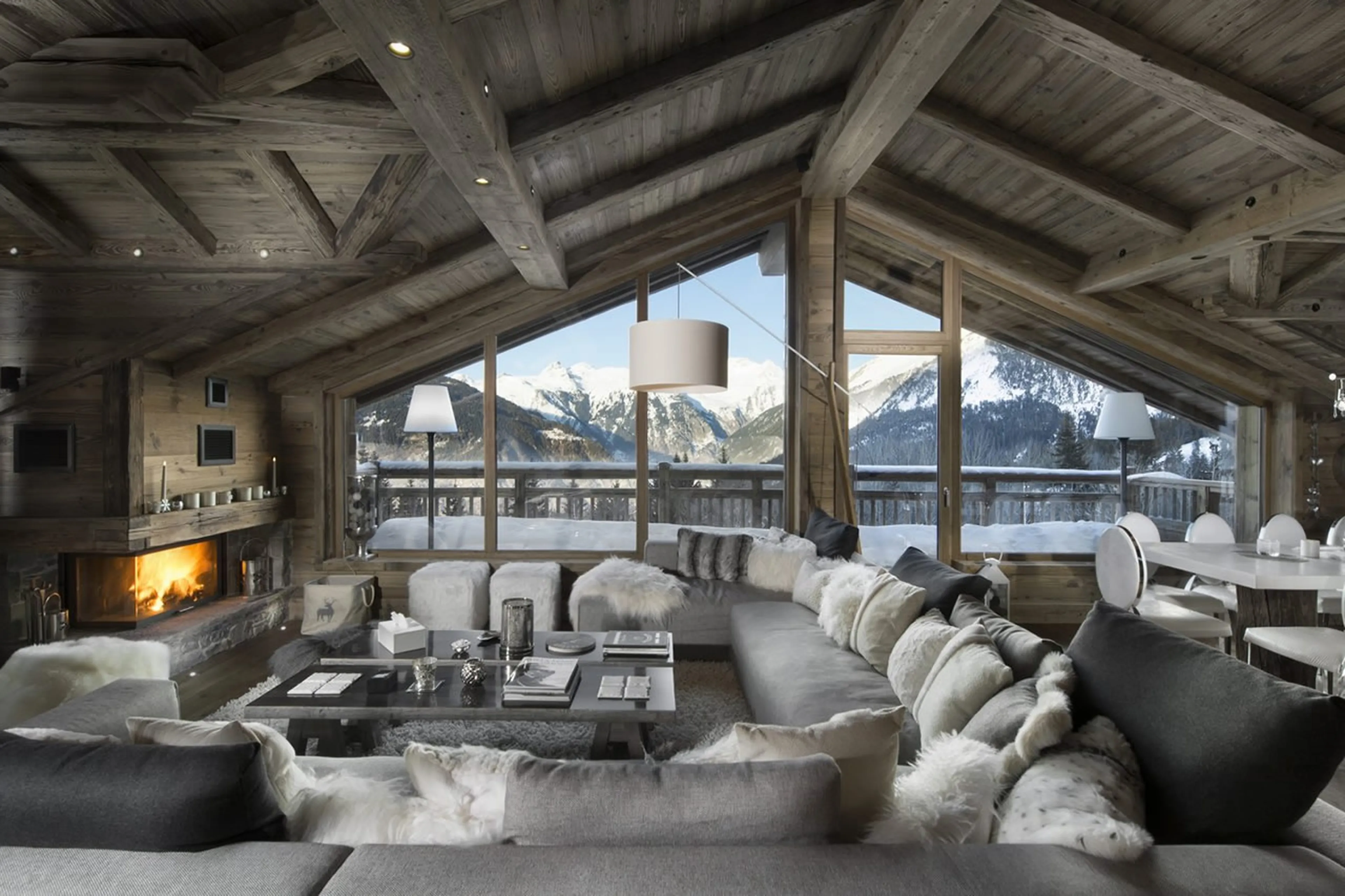 Open plan living area with balcony access and vaulted ceiling in Chalet L’ Or Blanc in Courchevel 15
