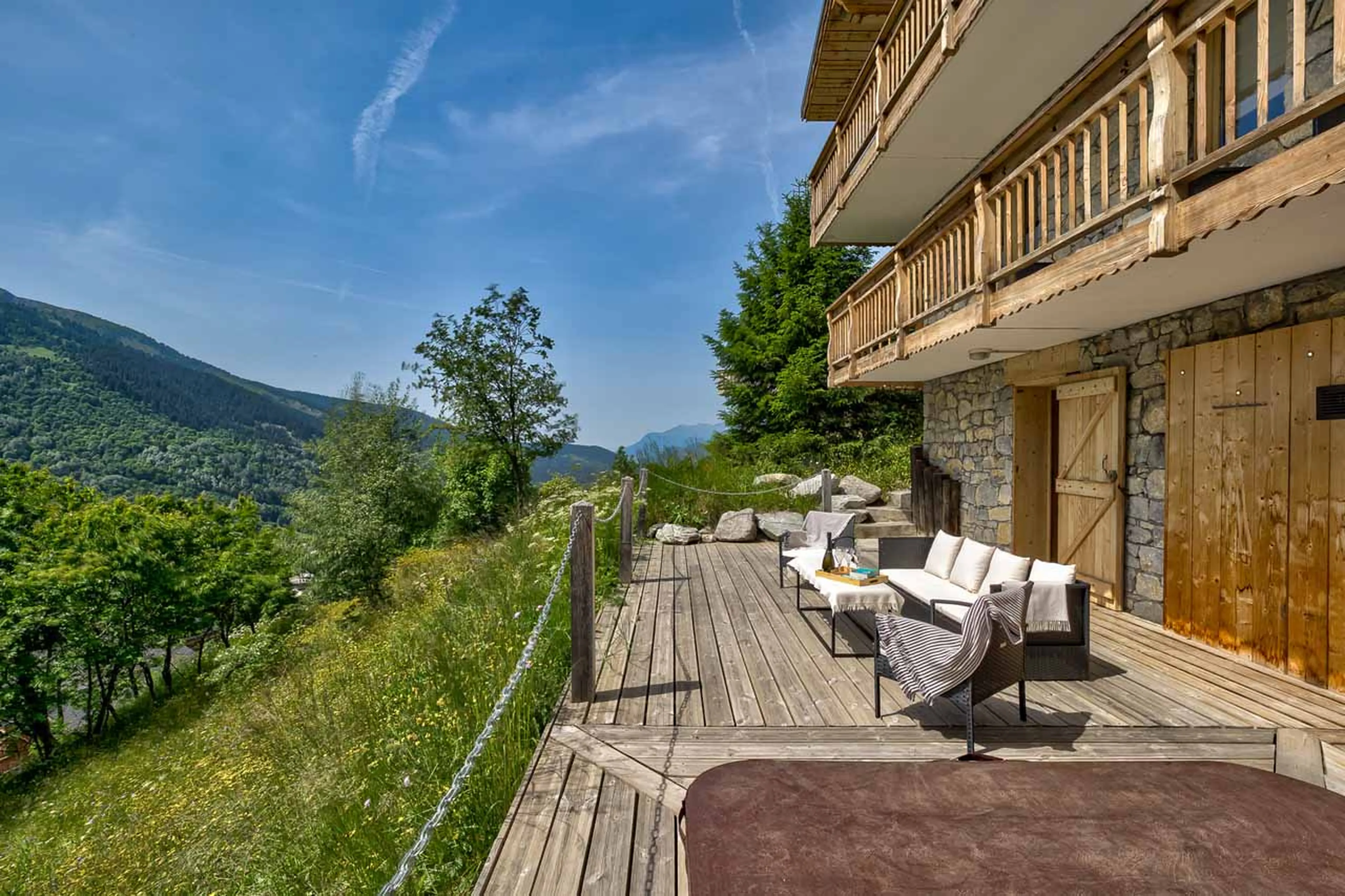 Sun terrace with hot tub at Chalet La Chouette in Meribel