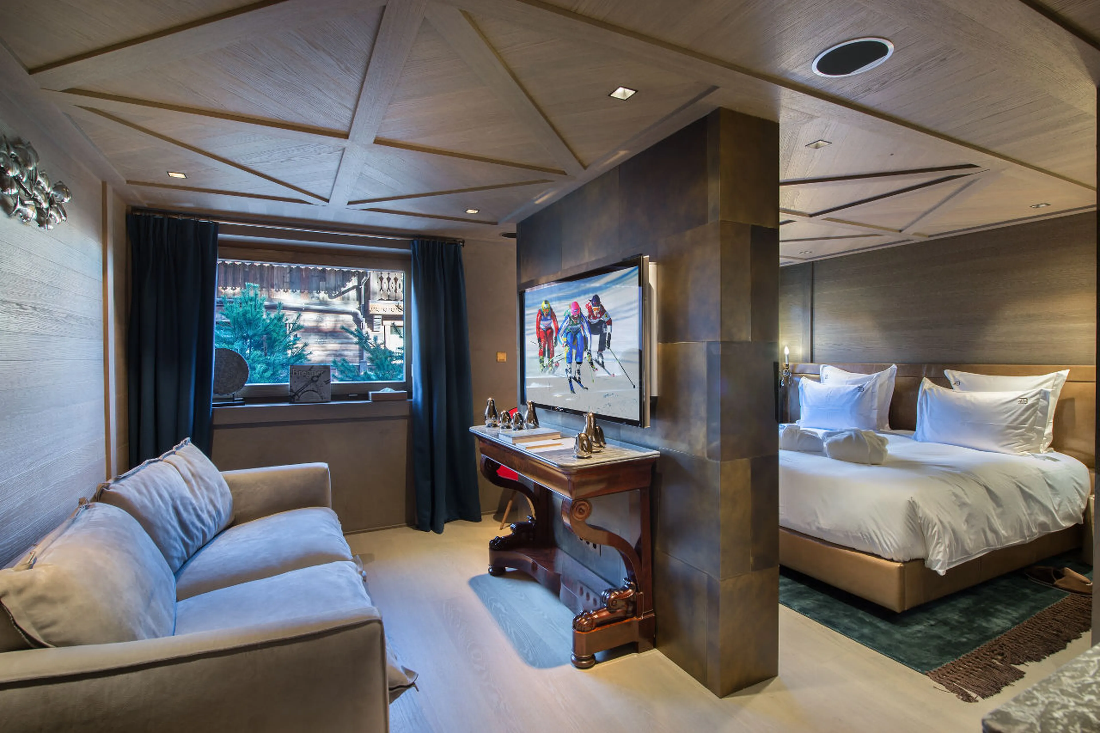 Double bedroom with private TV lounge area in La Datcha in Courchevel 1850