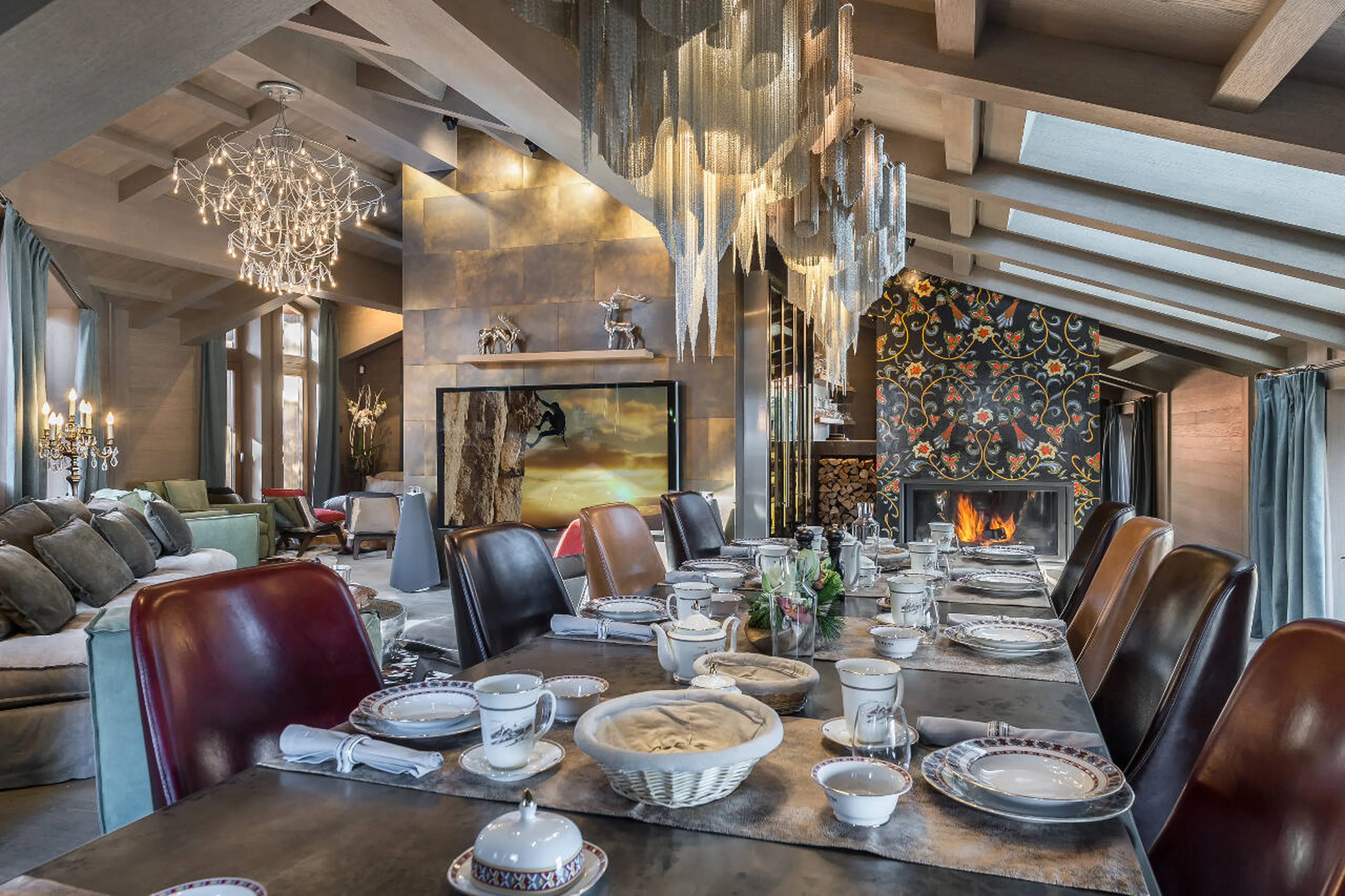 Dining table basking in the heat of the fireplace in La Datcha in Courchevel 1850