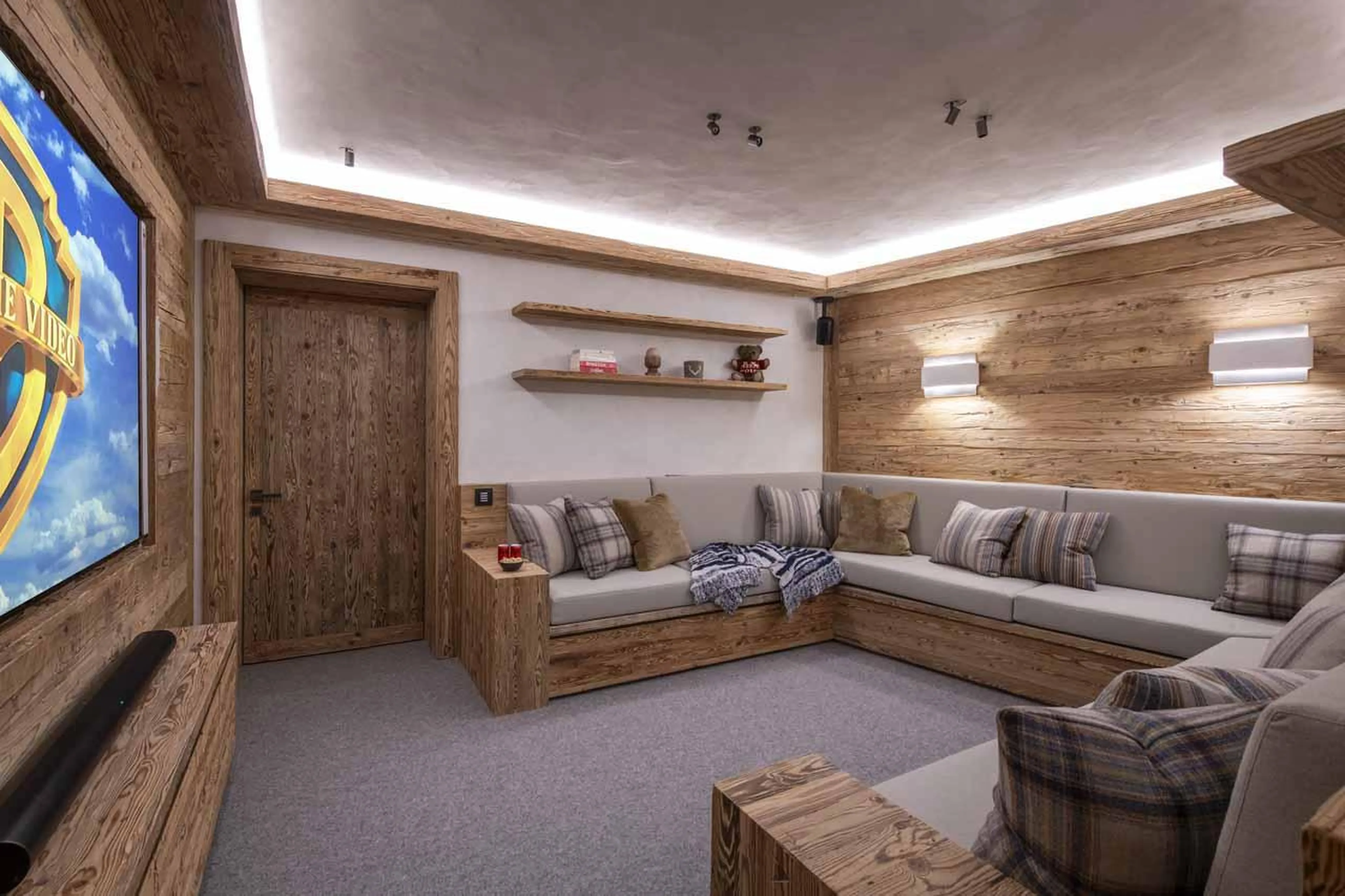 Cinema room with wrap-around sofa in Chalet La Rochette, Verbier