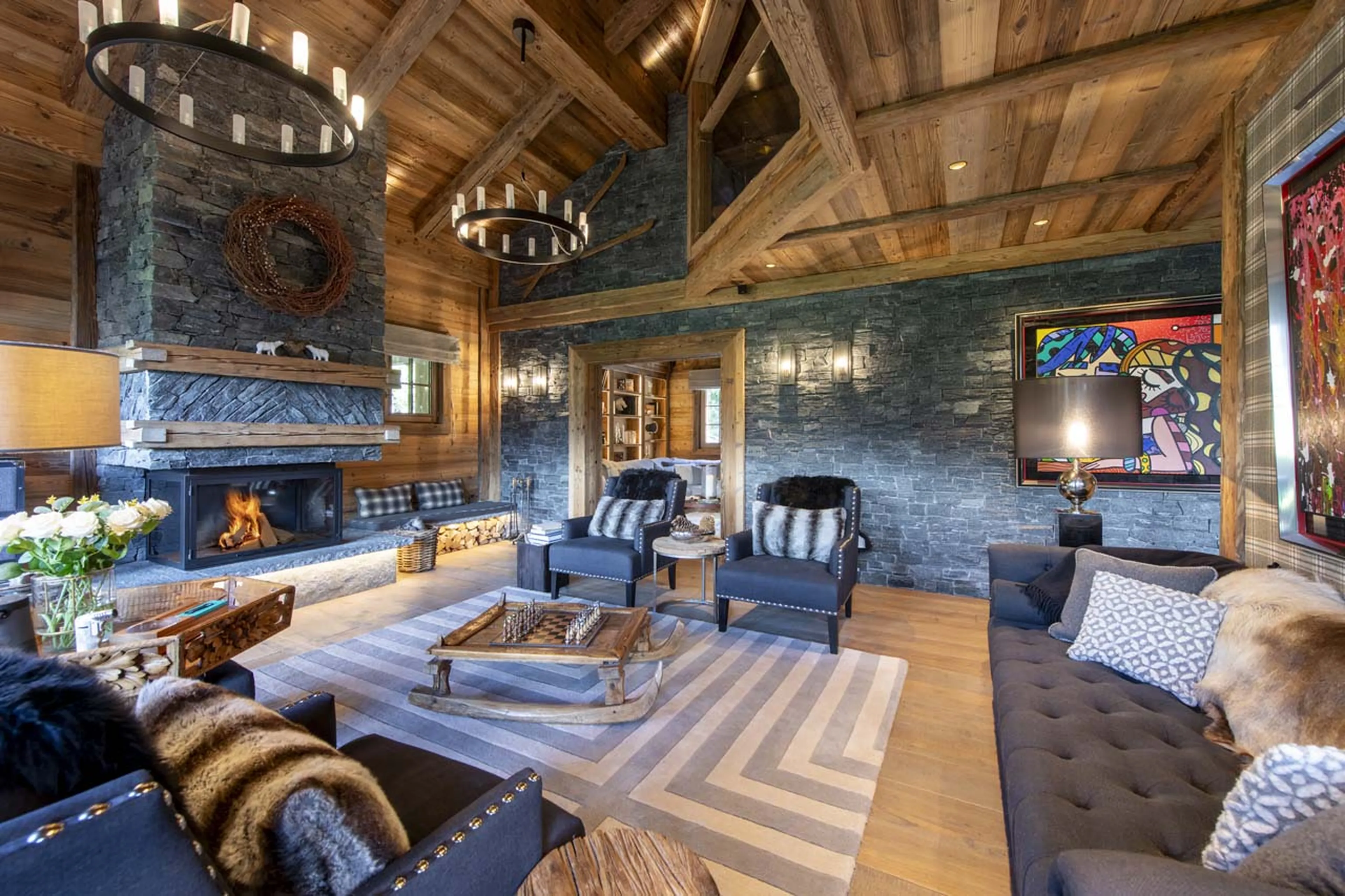 Living area with open fireplace in Chalet La Taniere, Meribel