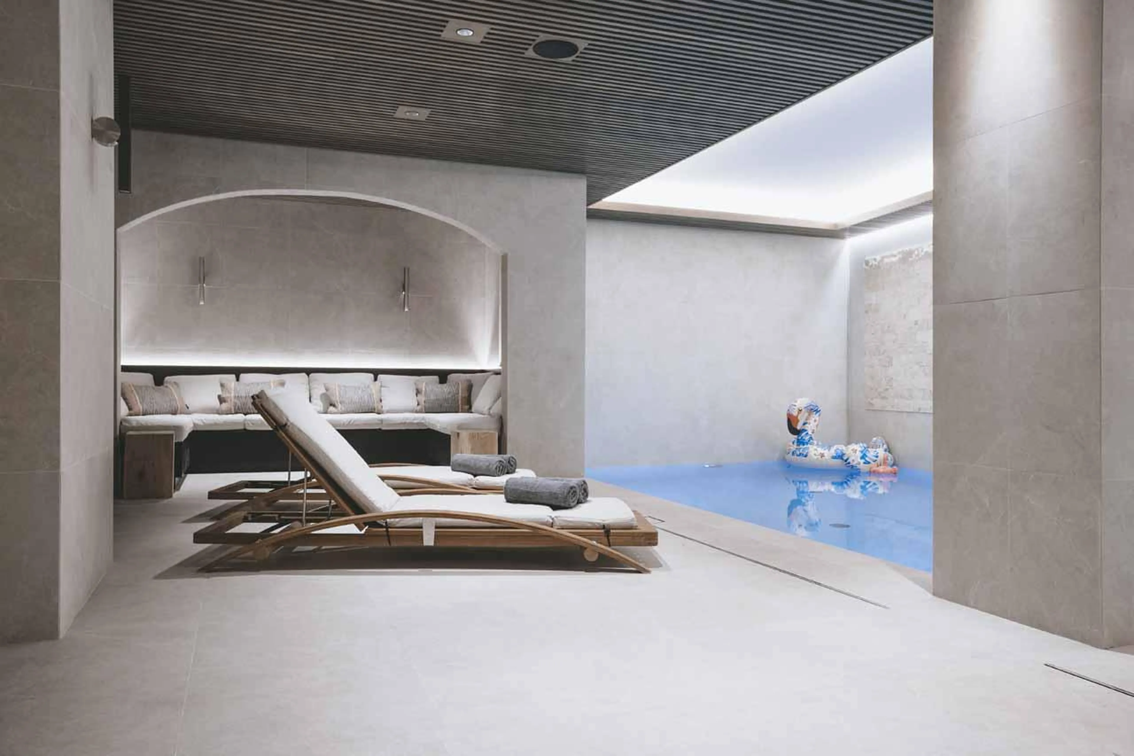 Loungers in relaxation area beside pool at Chalet La Tene, Val d'Isere