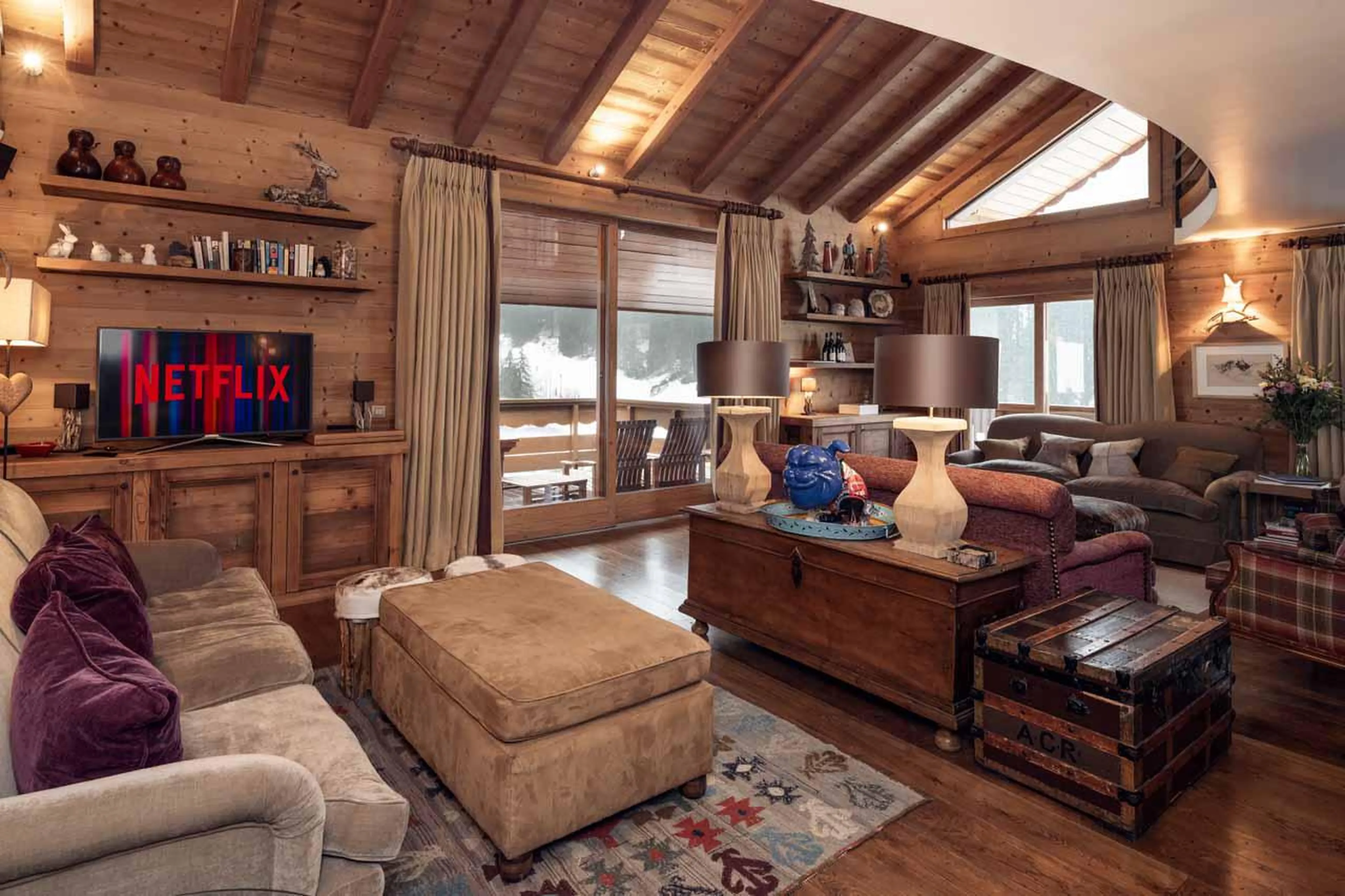 Large open-plan living space with cosy sofa area at Chalet Lapin Blanc in Meribel