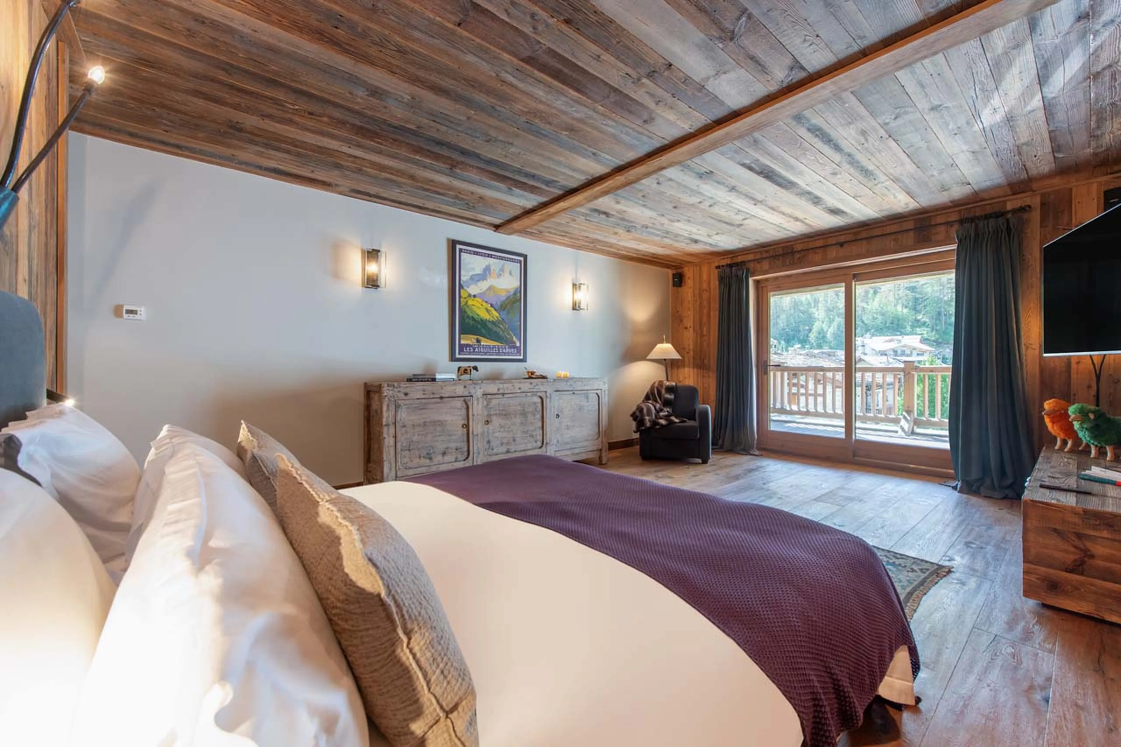 Bedroom one with terrace access at Chalet Lashca in Val d'Isere