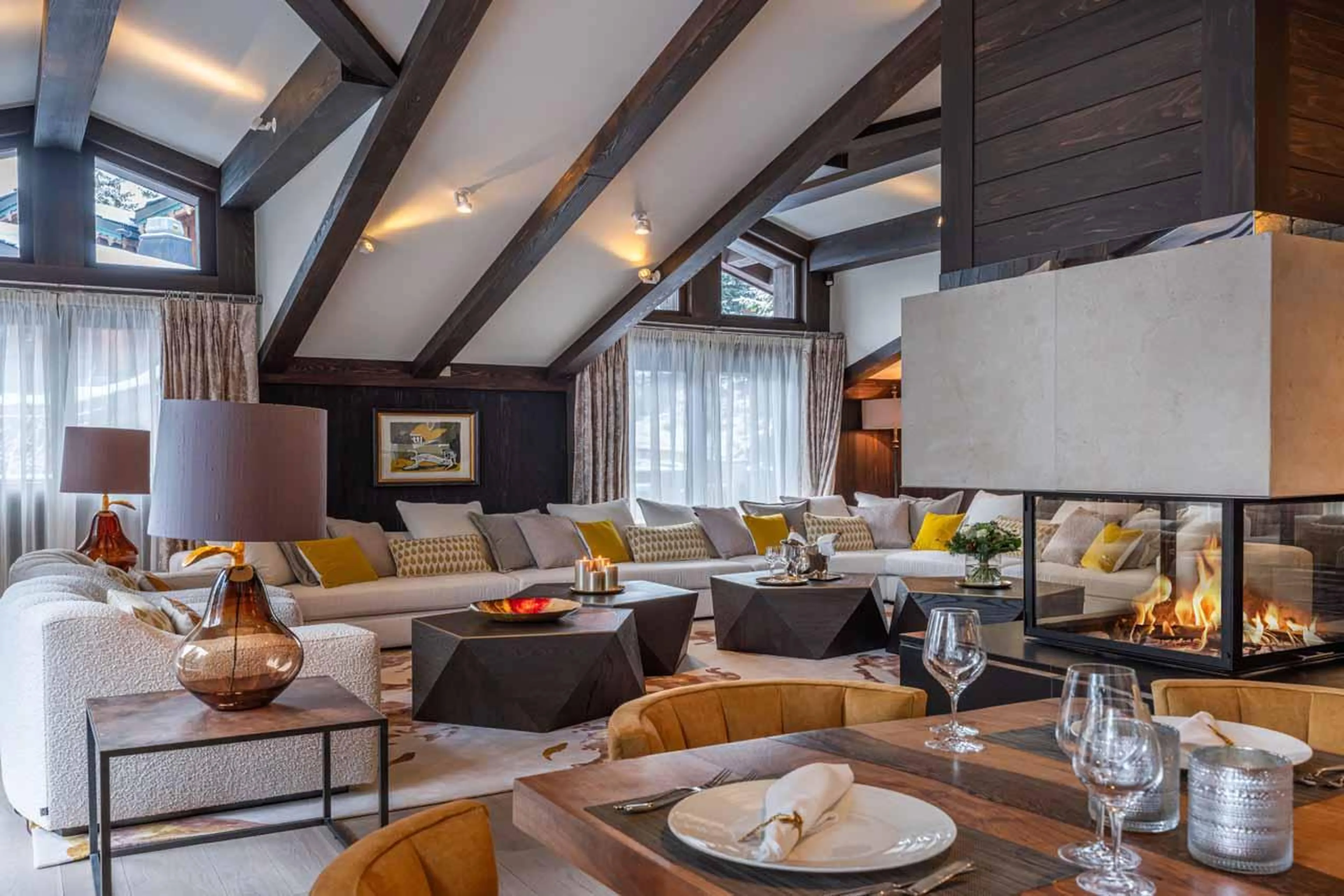 Fireplace and dining table in Chalet Le Coquelicot in Courchevel 1850