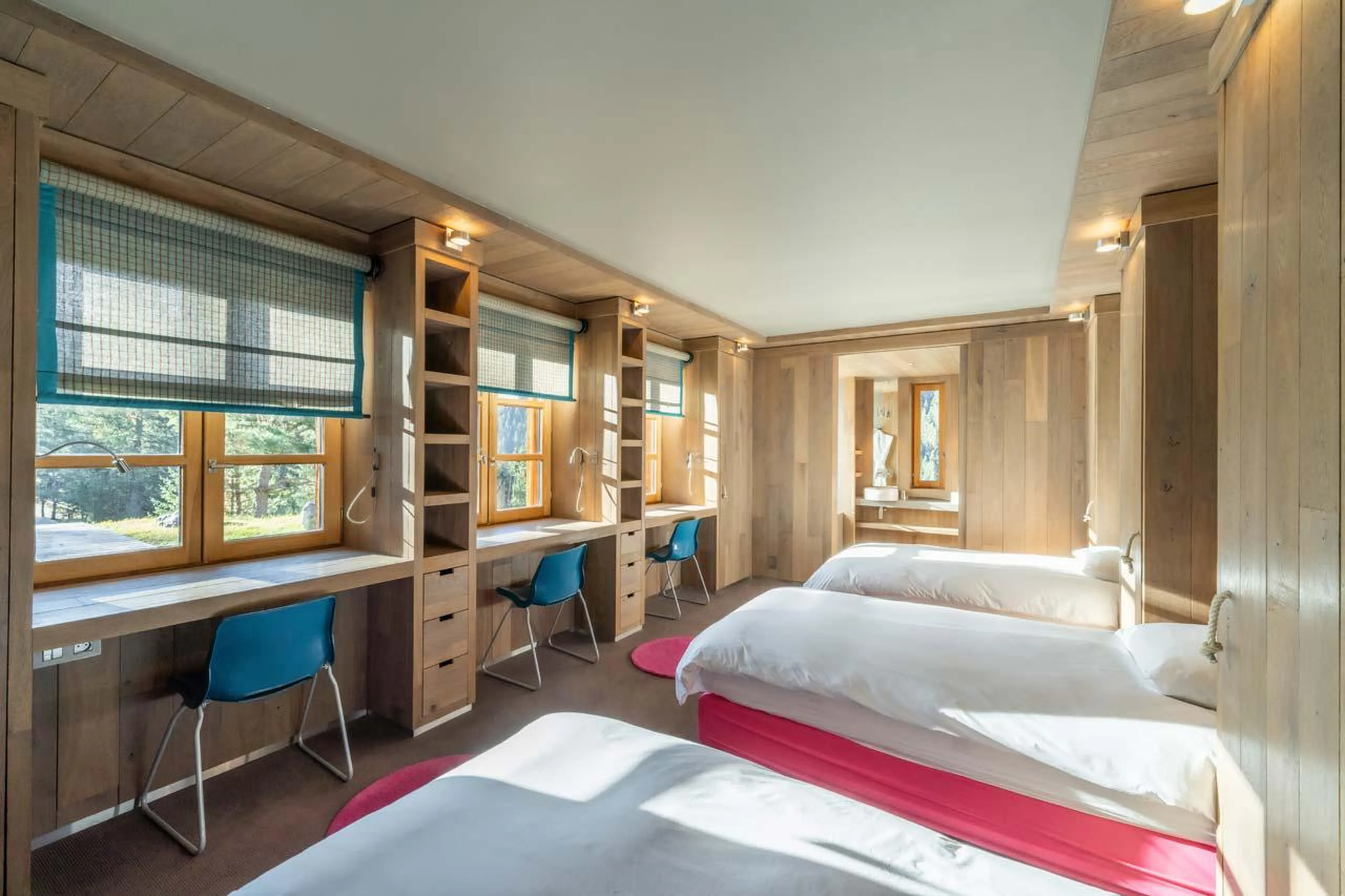 Spacious bedroom with modern wooden furnishings at Le Grand Cerf in Meribel