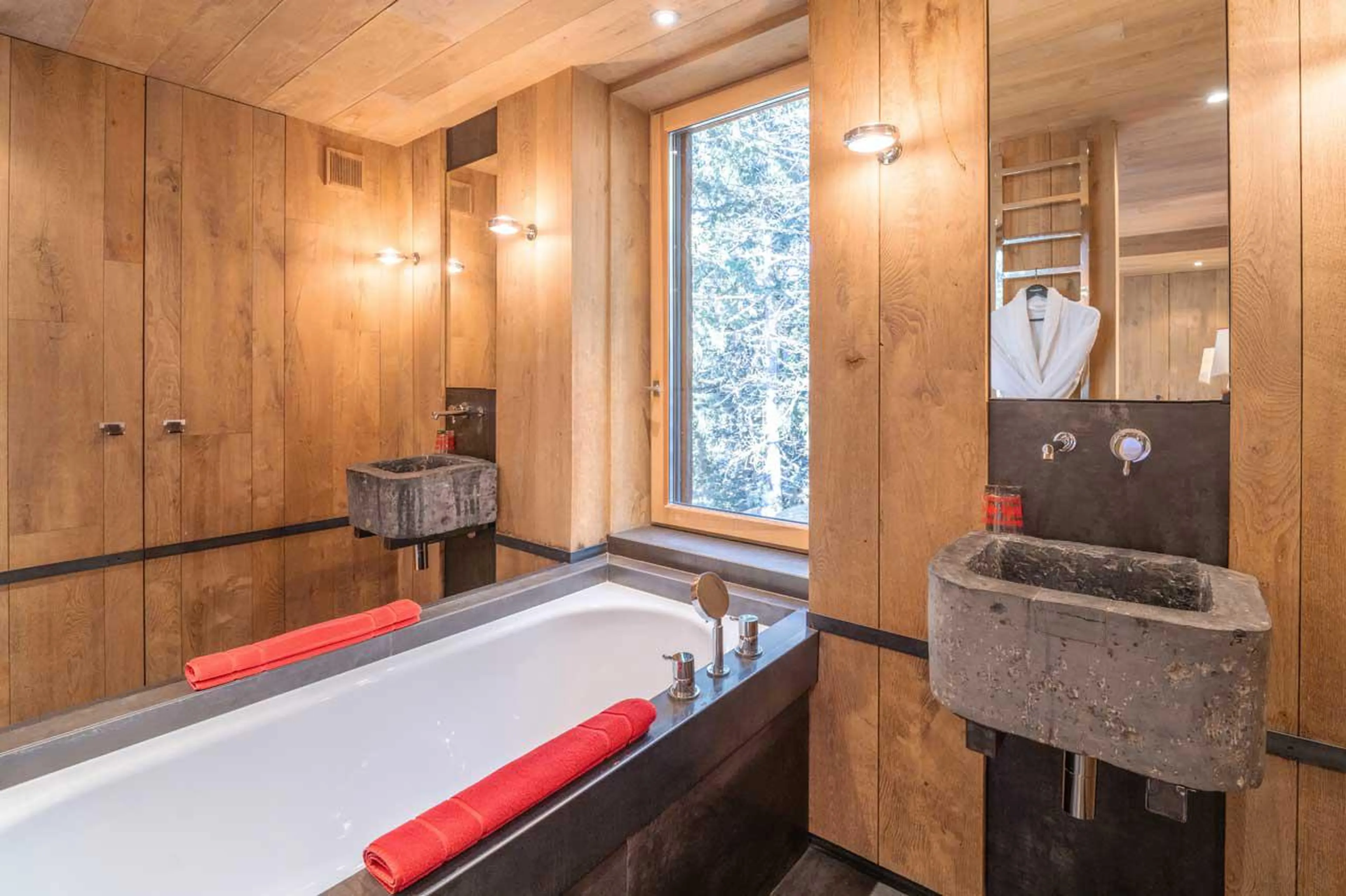 En-suite bathroom with bath at Le Grand Cerf in Meribel