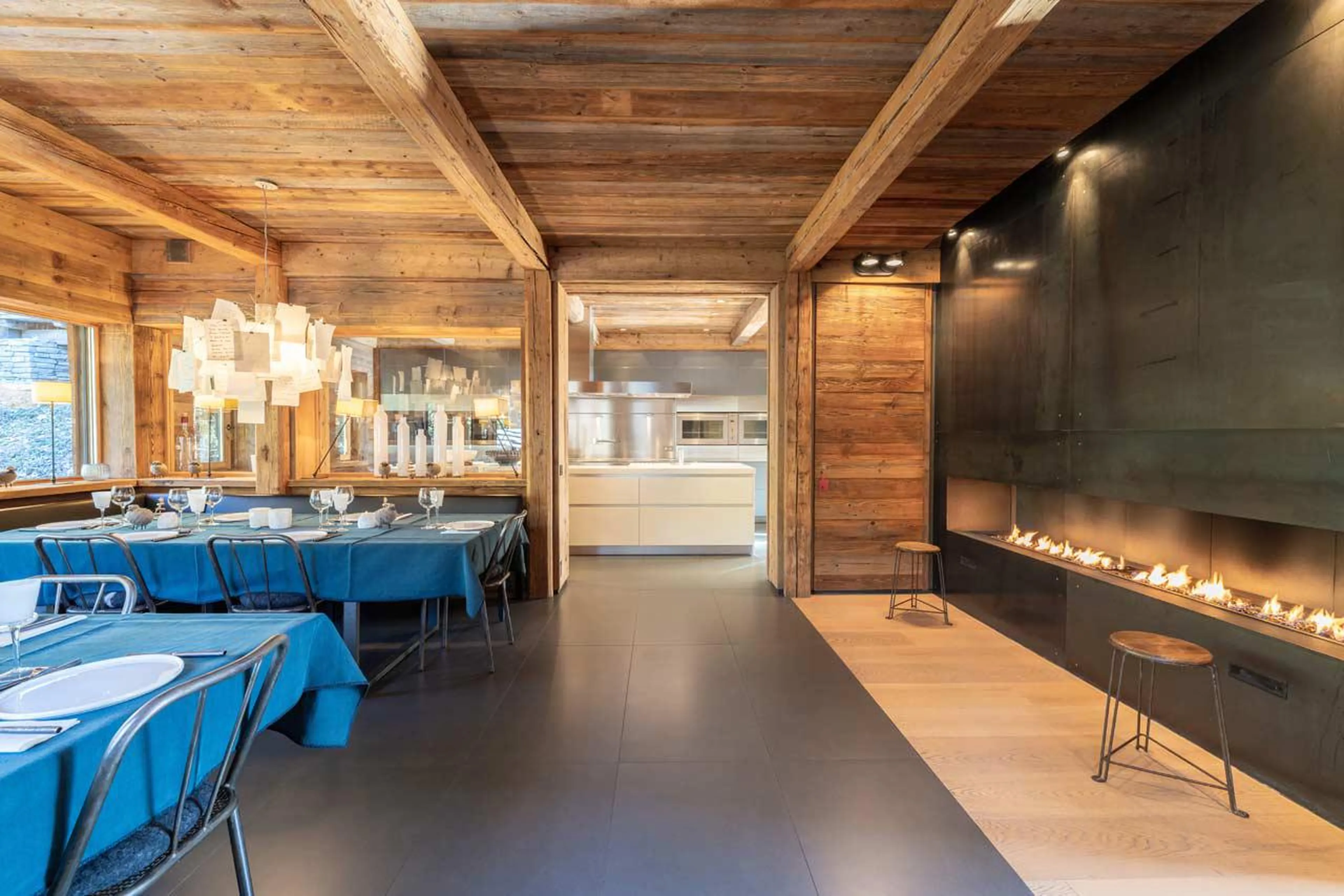 Dining room with gas fireplace at Le Grand Cerf in Meribel