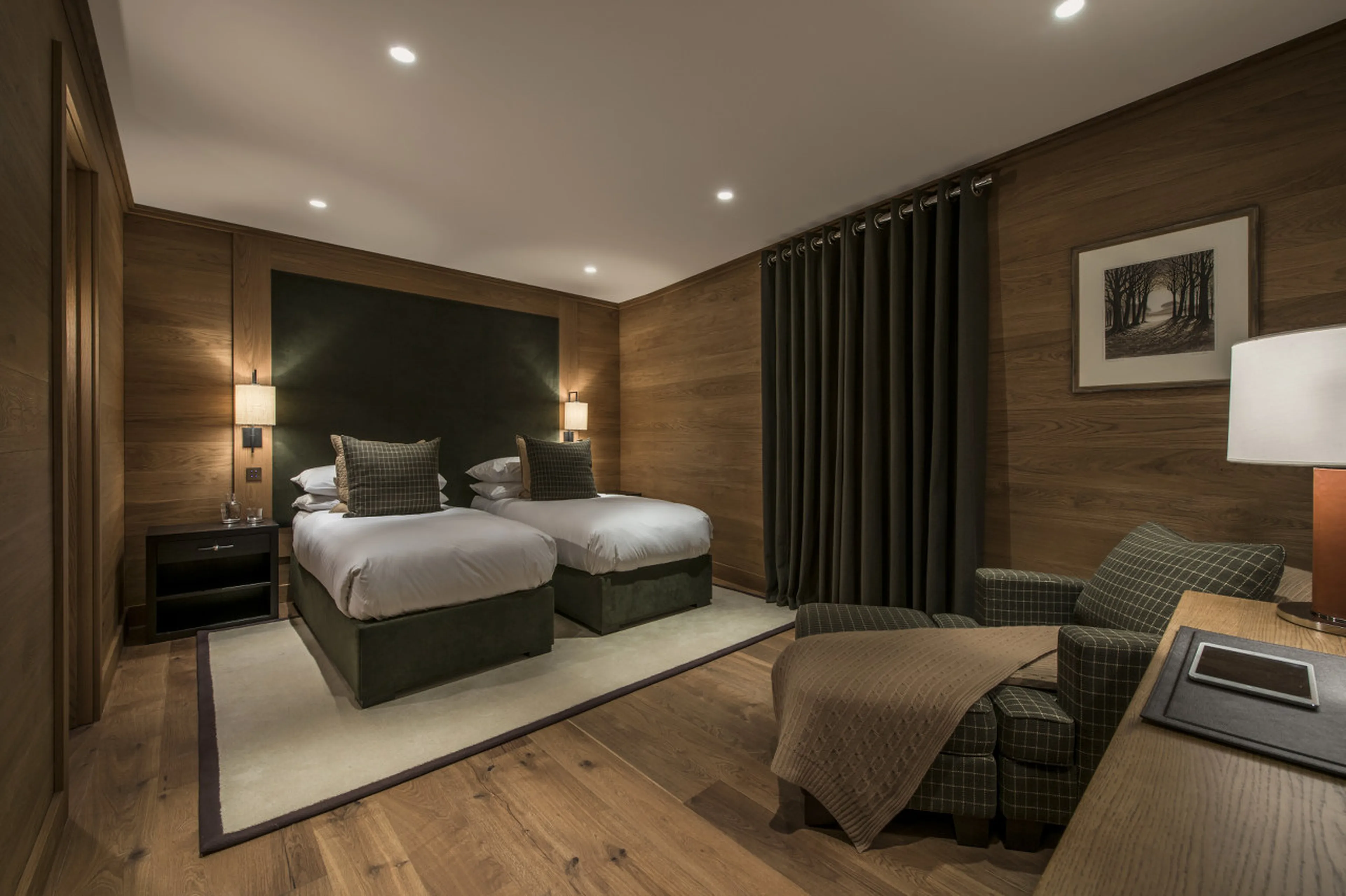 Bedroom with double/twin beds and dressing area in Chalet Le Grenier in Meribel