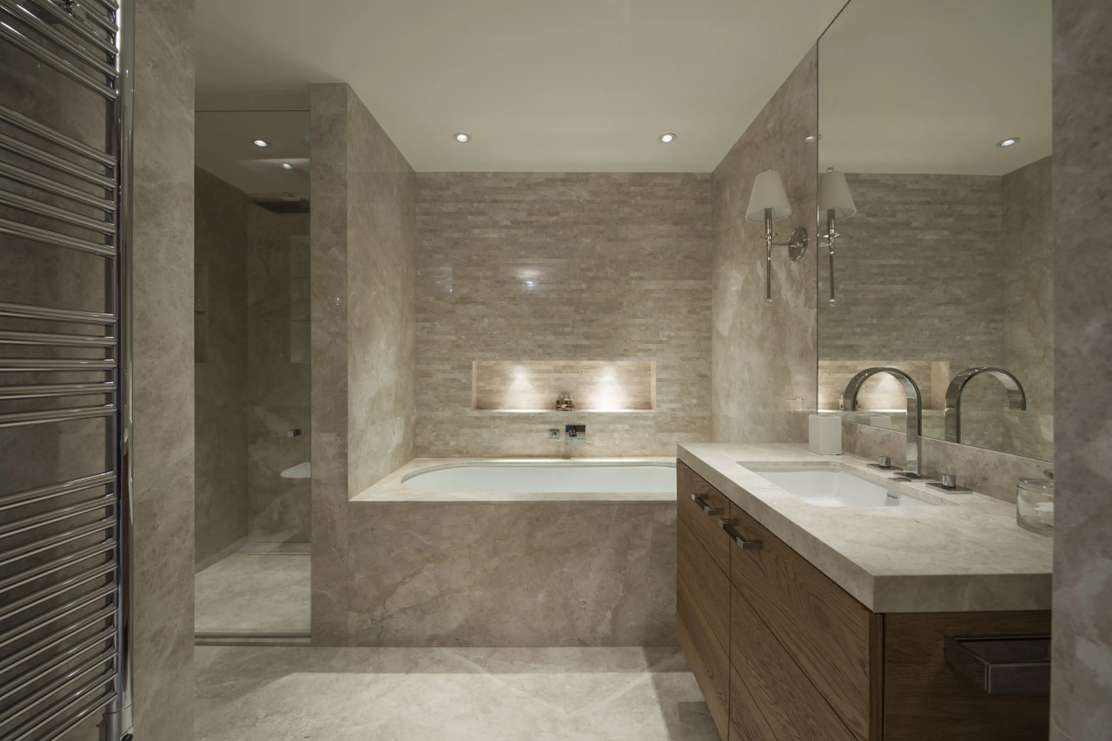En-suite bathroom with bath and shower in Chalet Le Grenier in Meribel