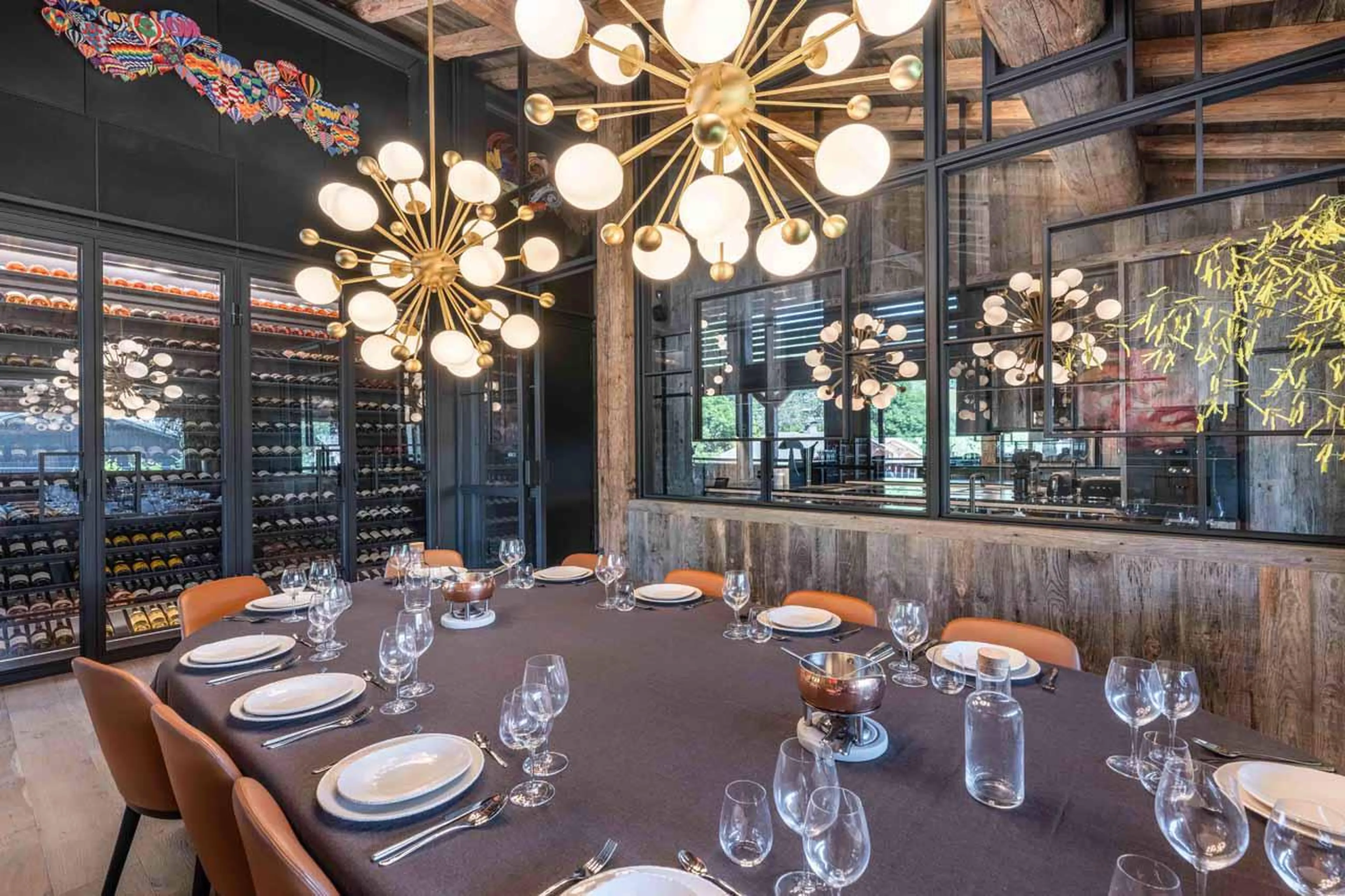 Dining table with stylish lighting in Chalet Le Lodge, Megeve